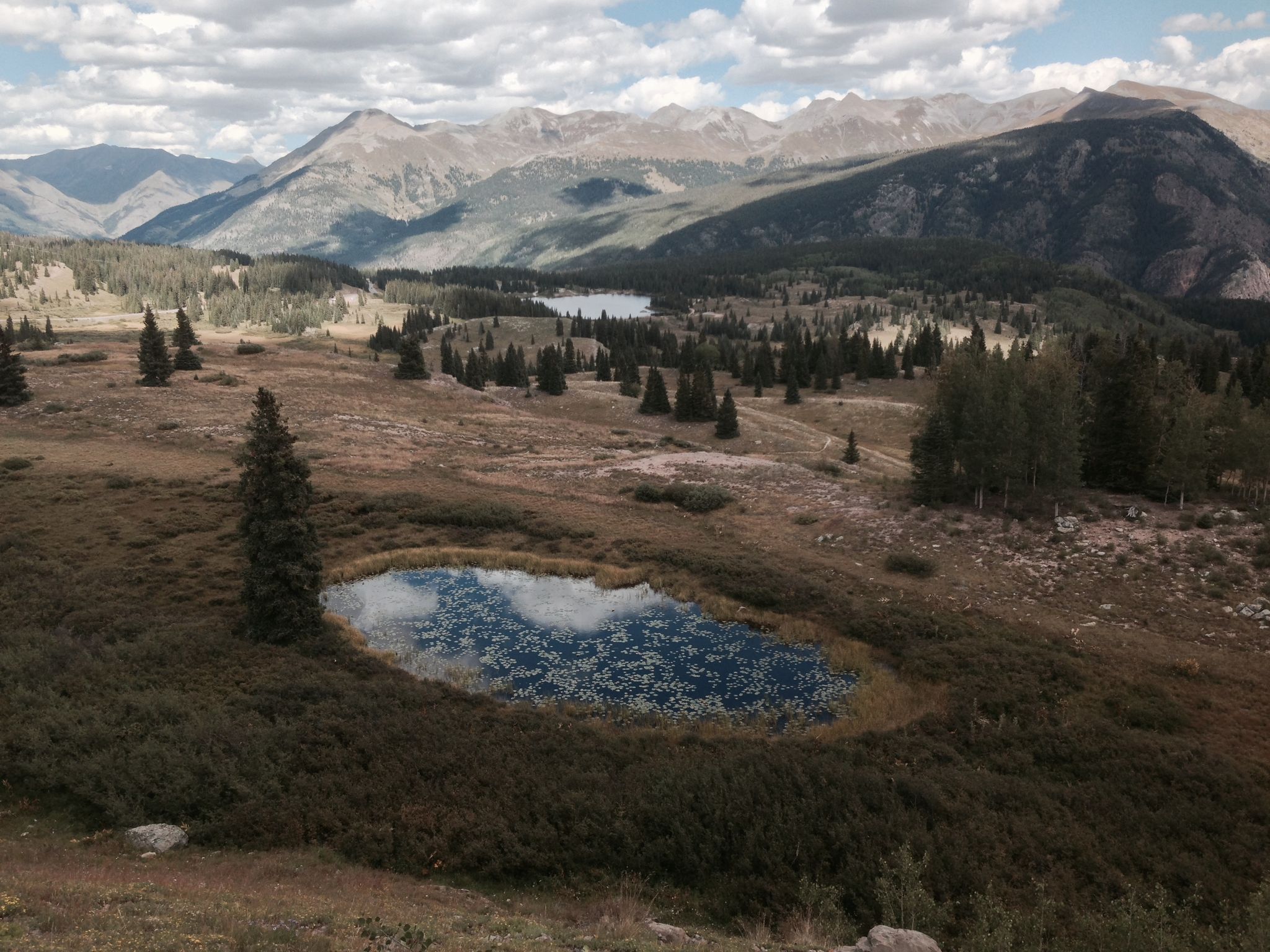 Elevated view of a mountain landscape with small lakes and scattered pine trees. - Coal Bank Pass – Molas Pass loop from Peregrine Parking