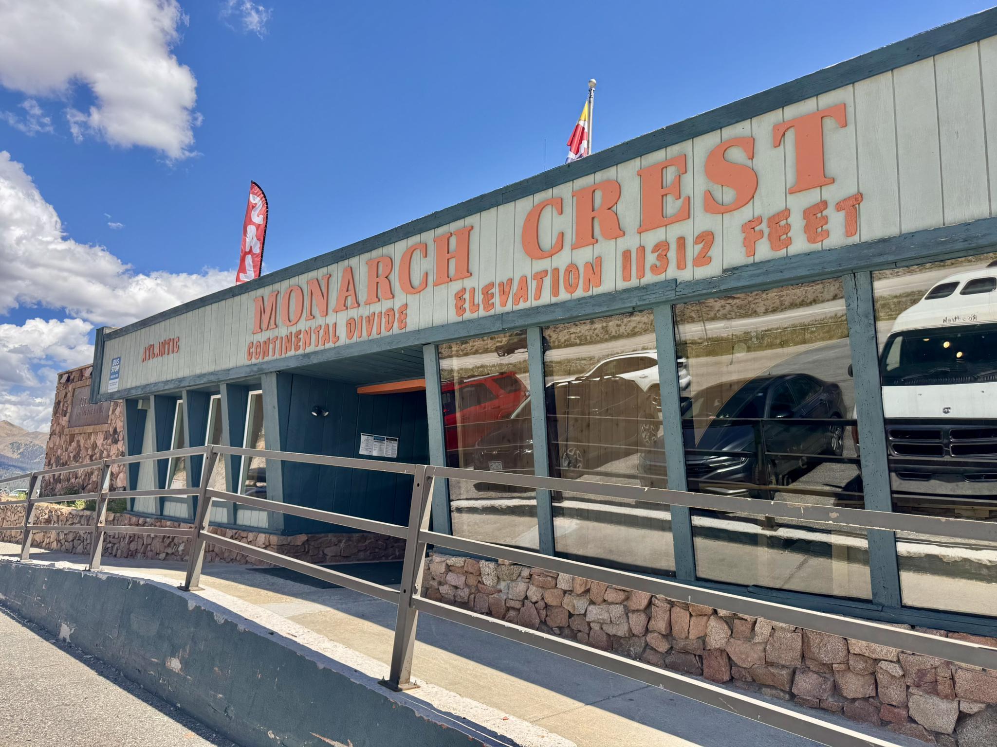 A building with 'MONARCH CREST' sign and reflective windows under a blue sky.