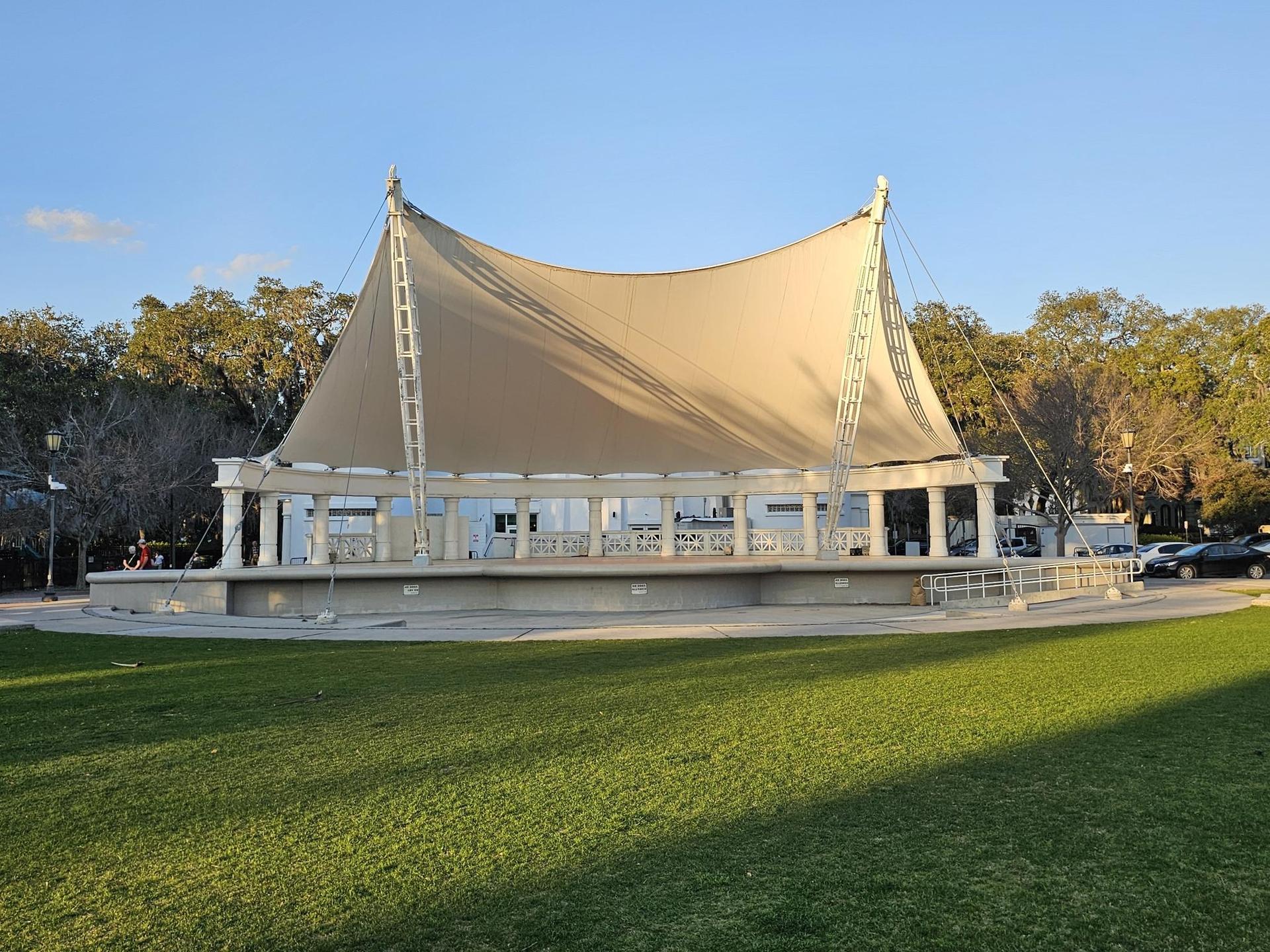 Large outdoor pavilion with a fabric roof on a sunny afternoon.
