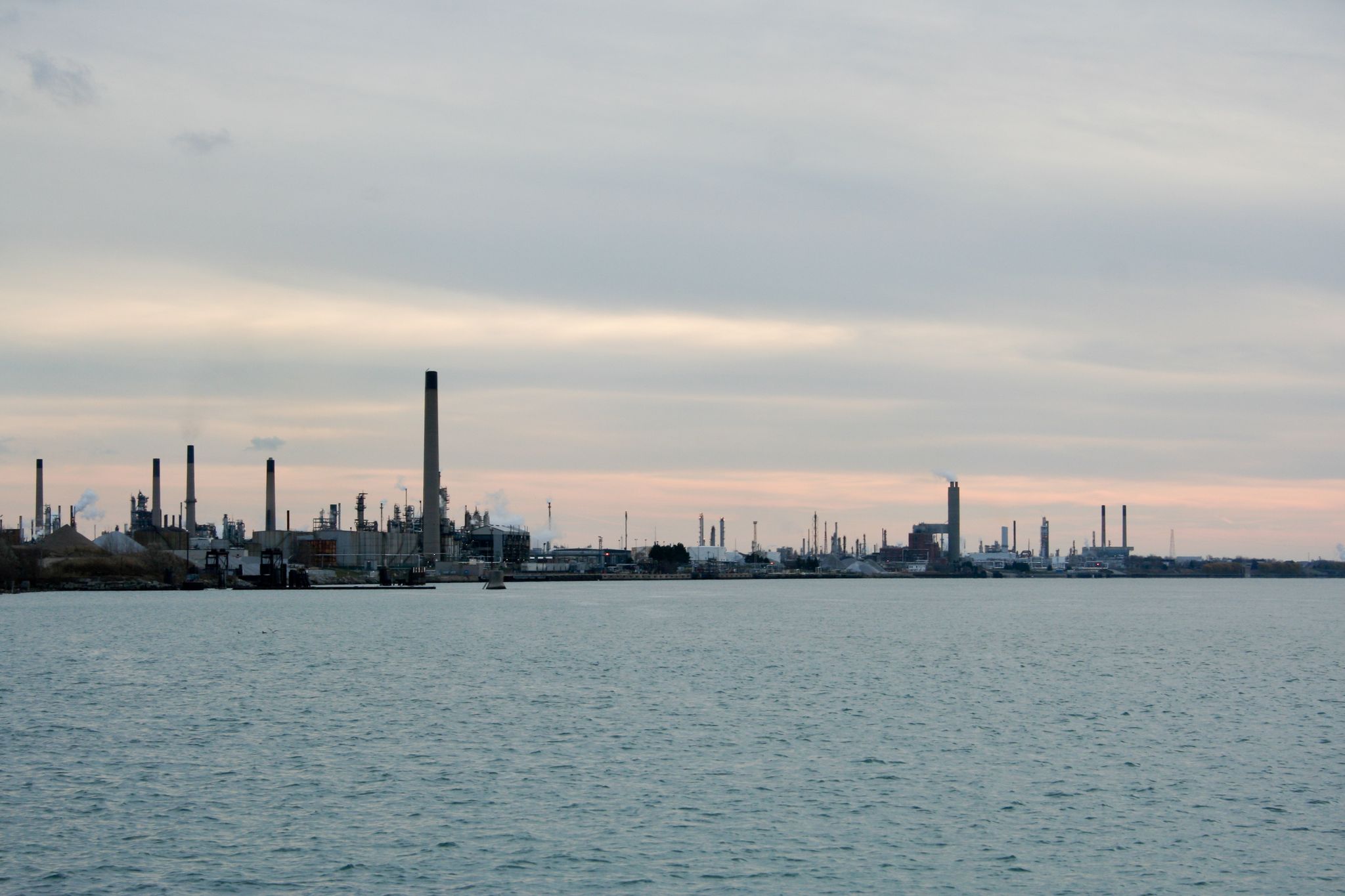 Industrial complex with many smokestacks along a waterfront under an overcast sky. - Bridge to Bay Trail loop from Port Huron