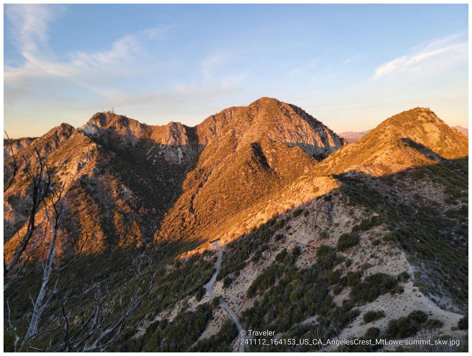 Rugged mountains bathed in warm, golden hour light.