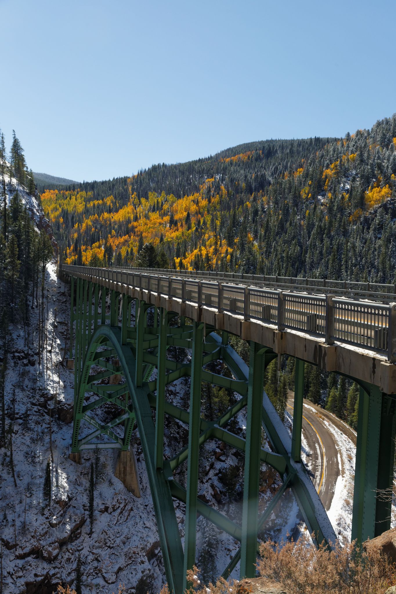 Large green bridge over a snowy canyon with autumn trees under clear skies. - Shrine Pass Road to Leadville and Fremont Pass loop from Vail Pass Summit — Gravel