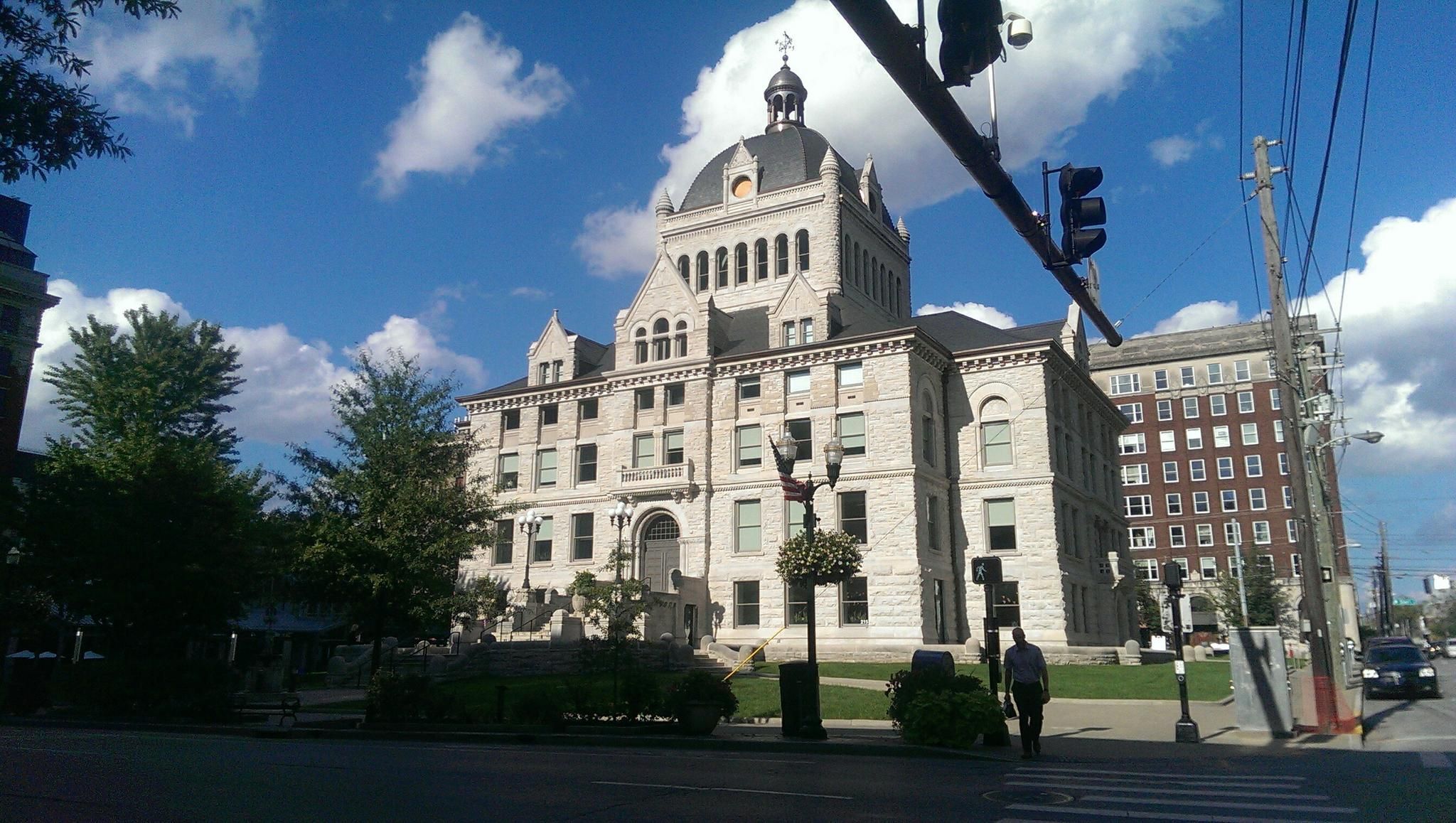 Ornate stone building with a dome under a bright, cloudy sky. - Bluegrass Bike Tour: Lexington to Georgetown Loop