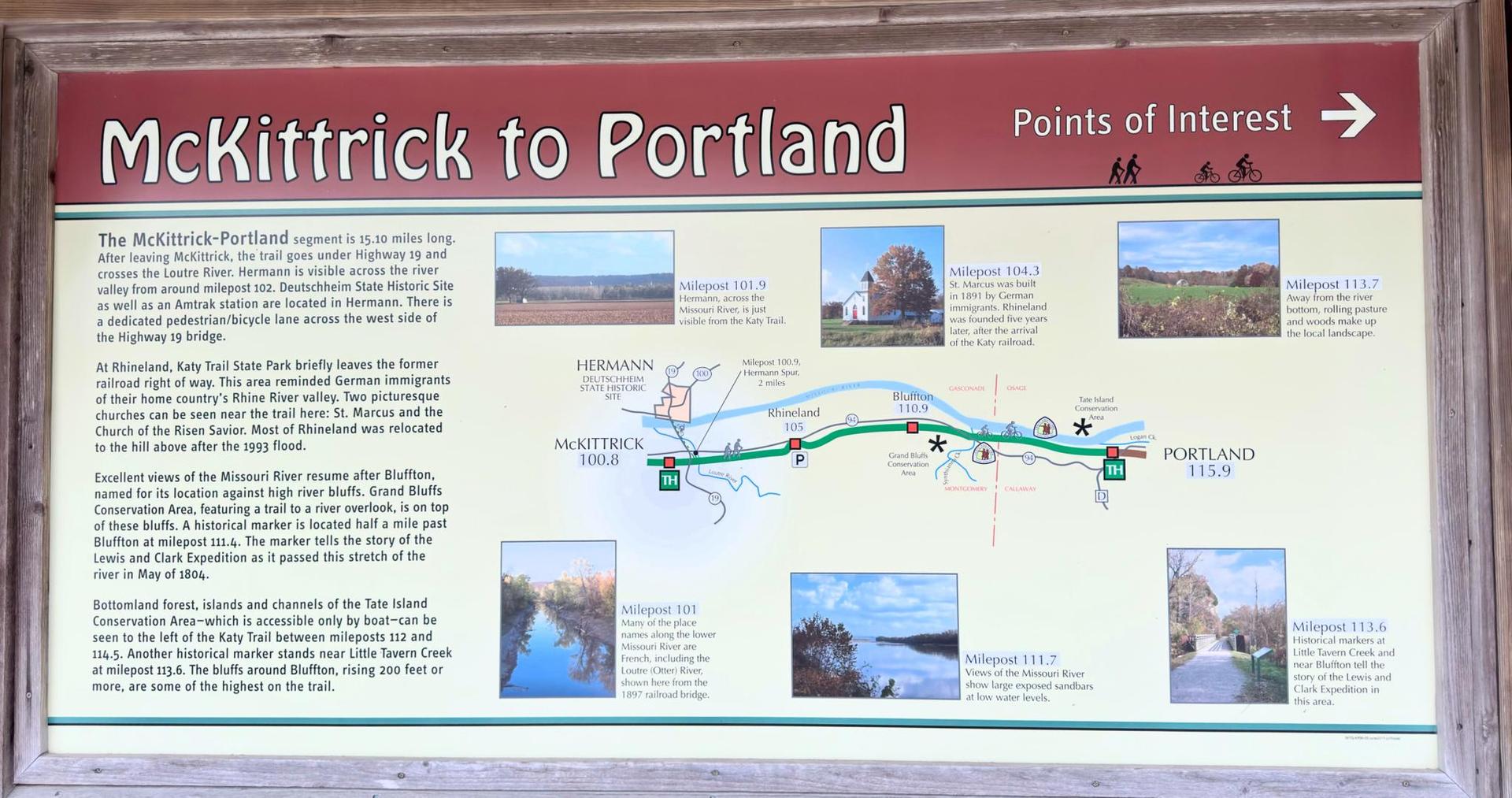 A wooden framed sign displays a map and text about points of interest.