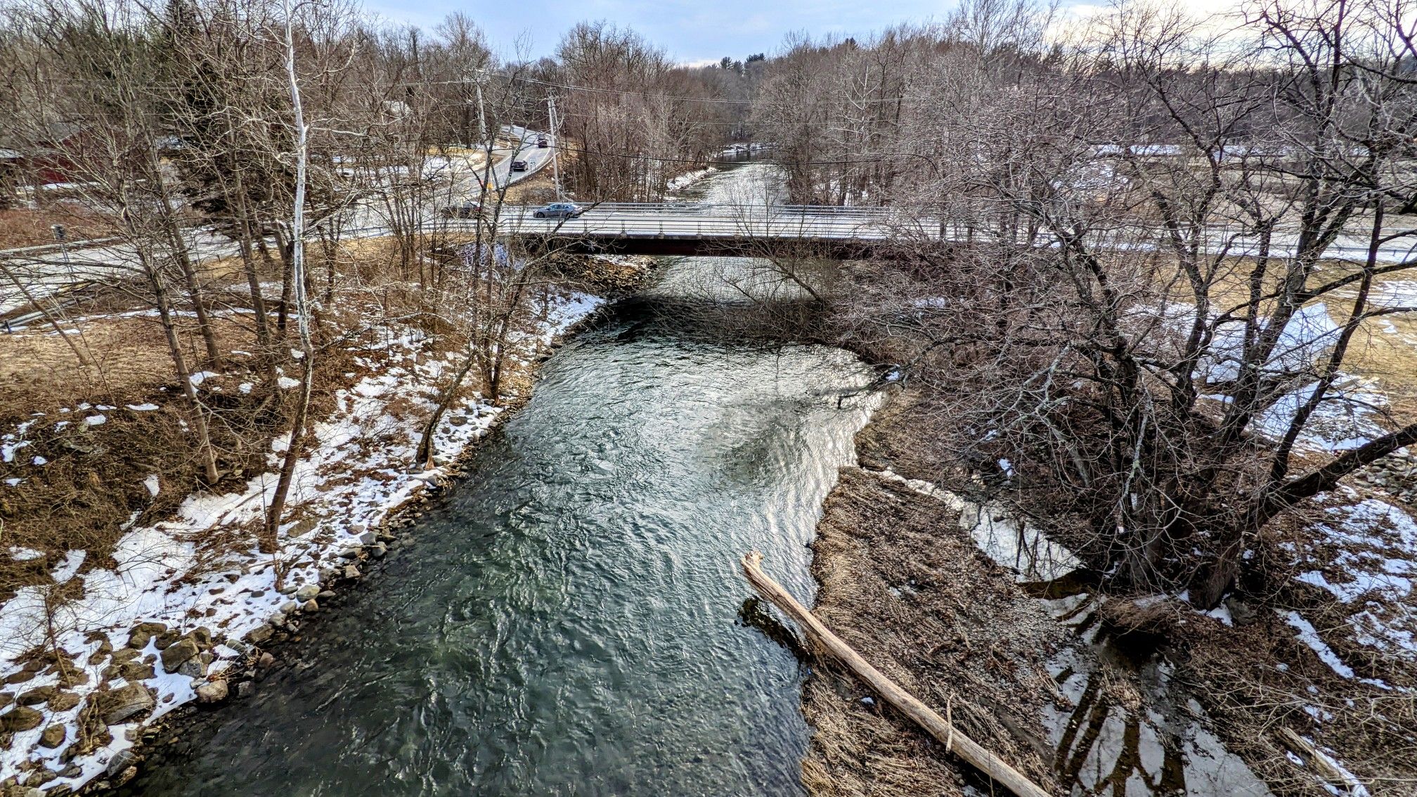 A river flows under a bridge in a snowy, winter landscape. - Dutchess Rail Trail – Dutchess Rail Trail loop from New Hackensack