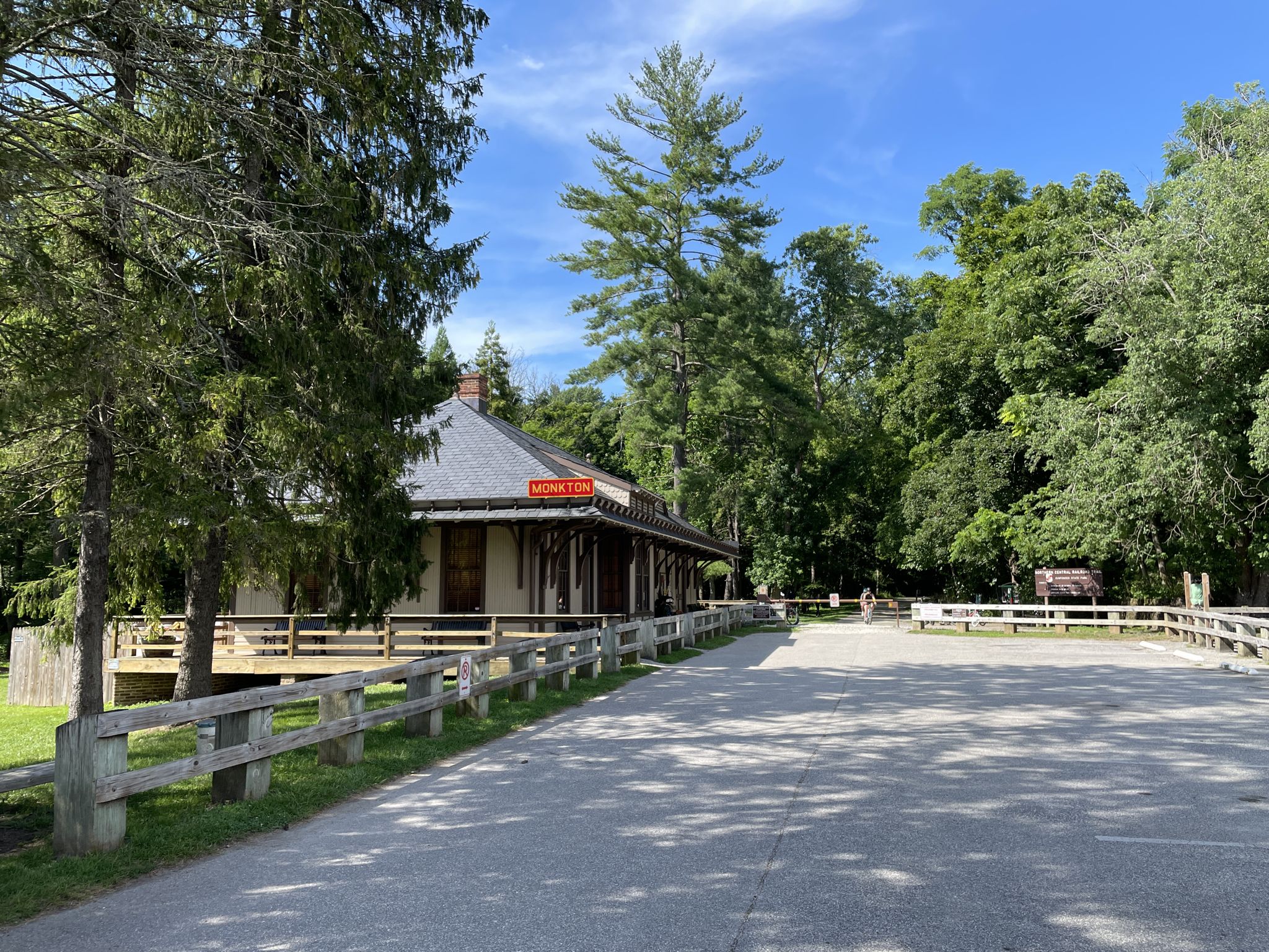 A historic building next to an empty parking lot under a blue sky. - Sparks Bank Nature Center – Monkton Train Station loop from Manor