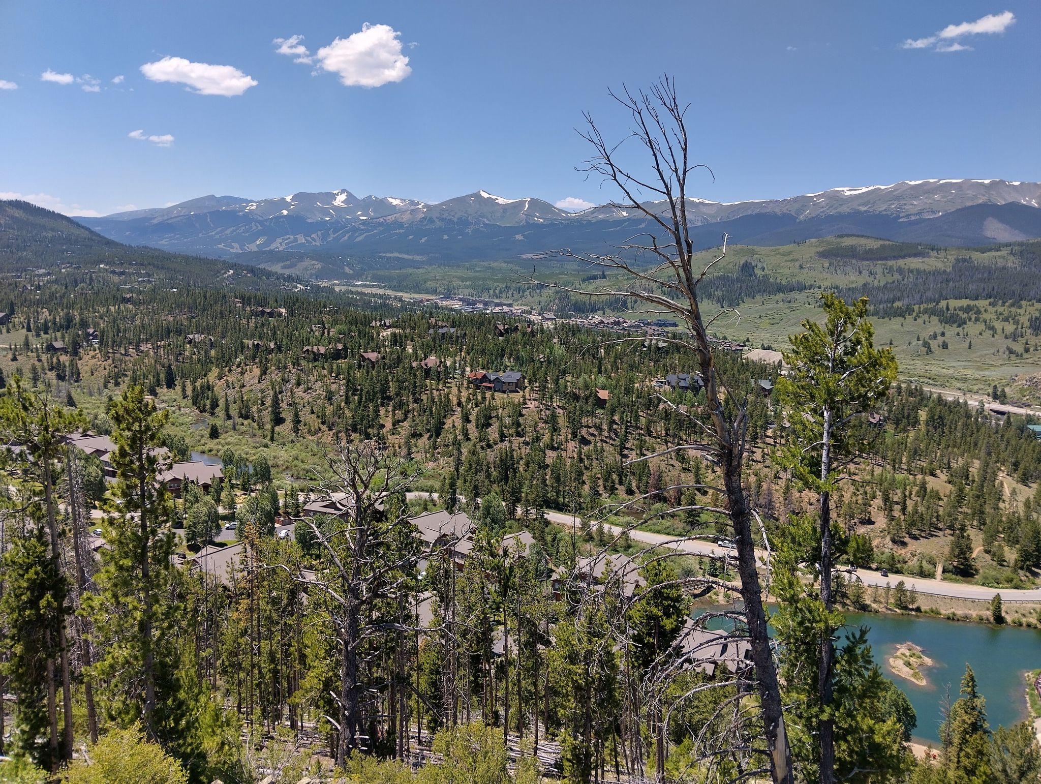 Panoramic view of a forested valley with a lake and distant snow-capped mountains. - Colorado Trail: Segment 6