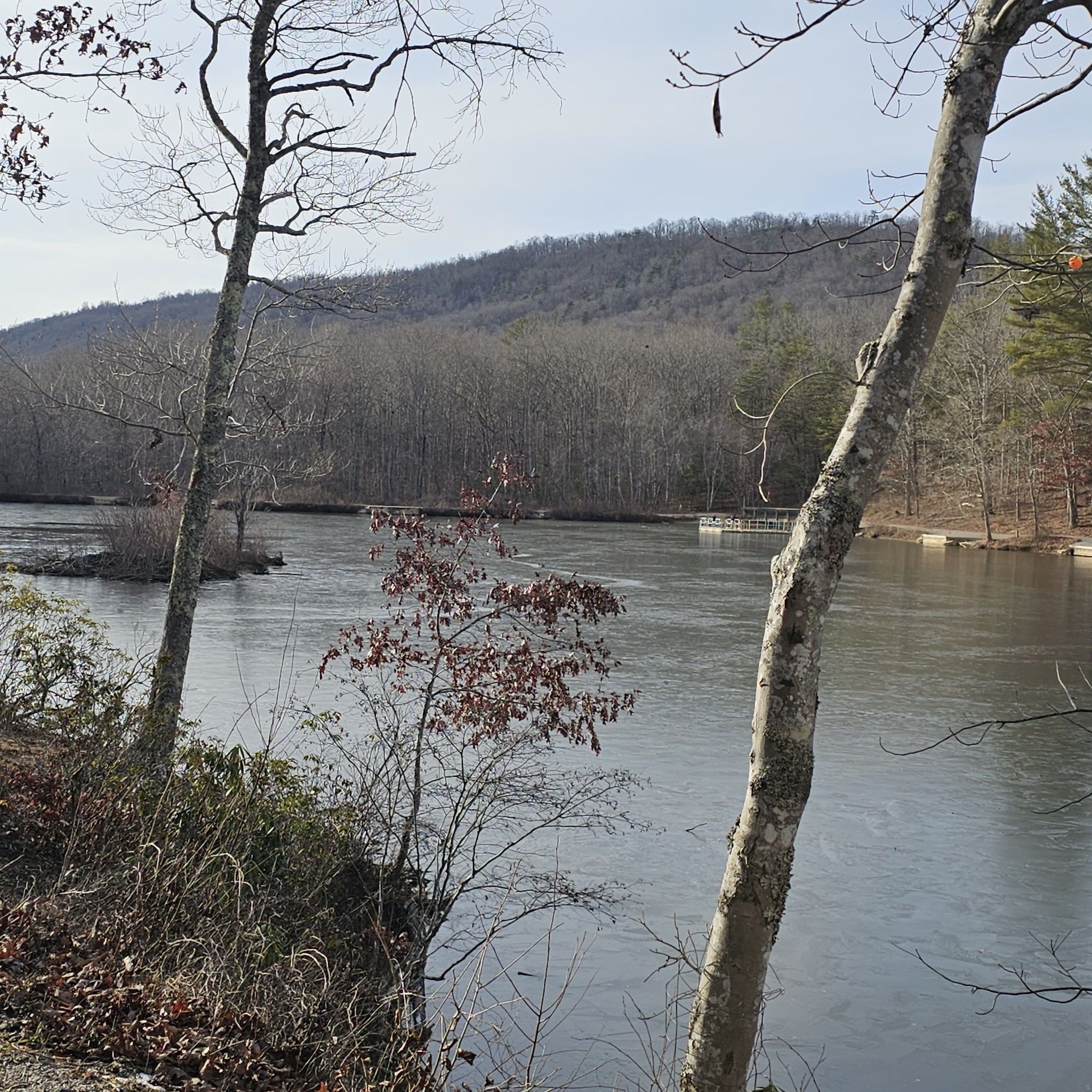 Icy lake surrounded by bare trees and distant hills on a clear day. - Stream View loop from Pandapas Pond Upper Lot Parking