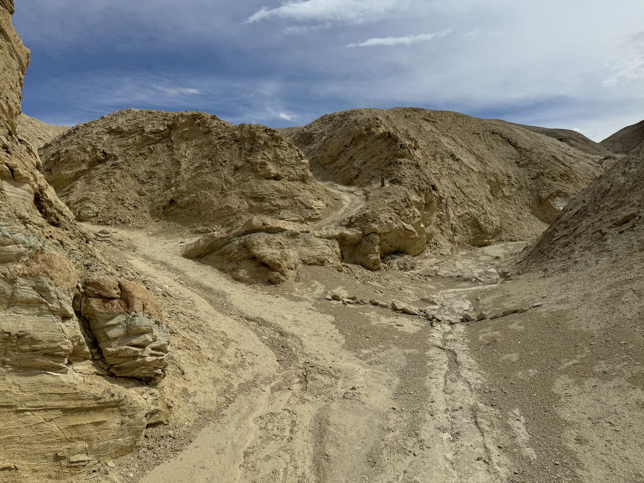 Narrow desert canyon with sandy wash and eroded rock formations. - Zabriskie Point – Manly Beacon loop from Zabriskie Point