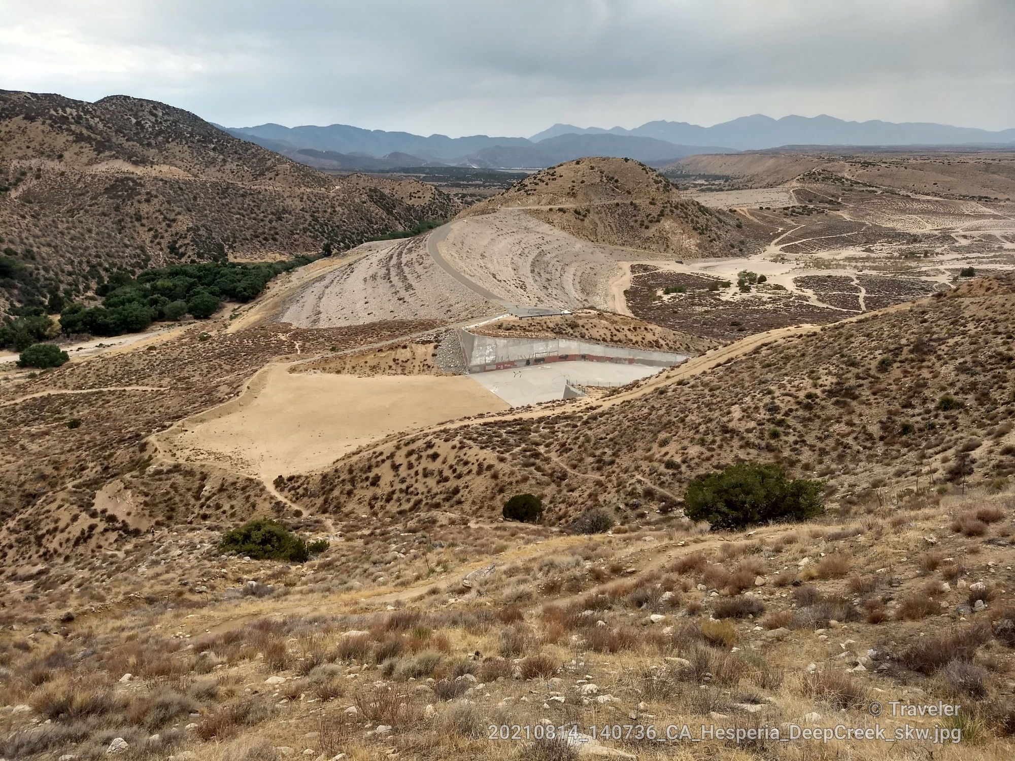 Overhead view of arid hills with a large, dry concrete structure. - Rainbow Bridge via Pacific Crest Trail