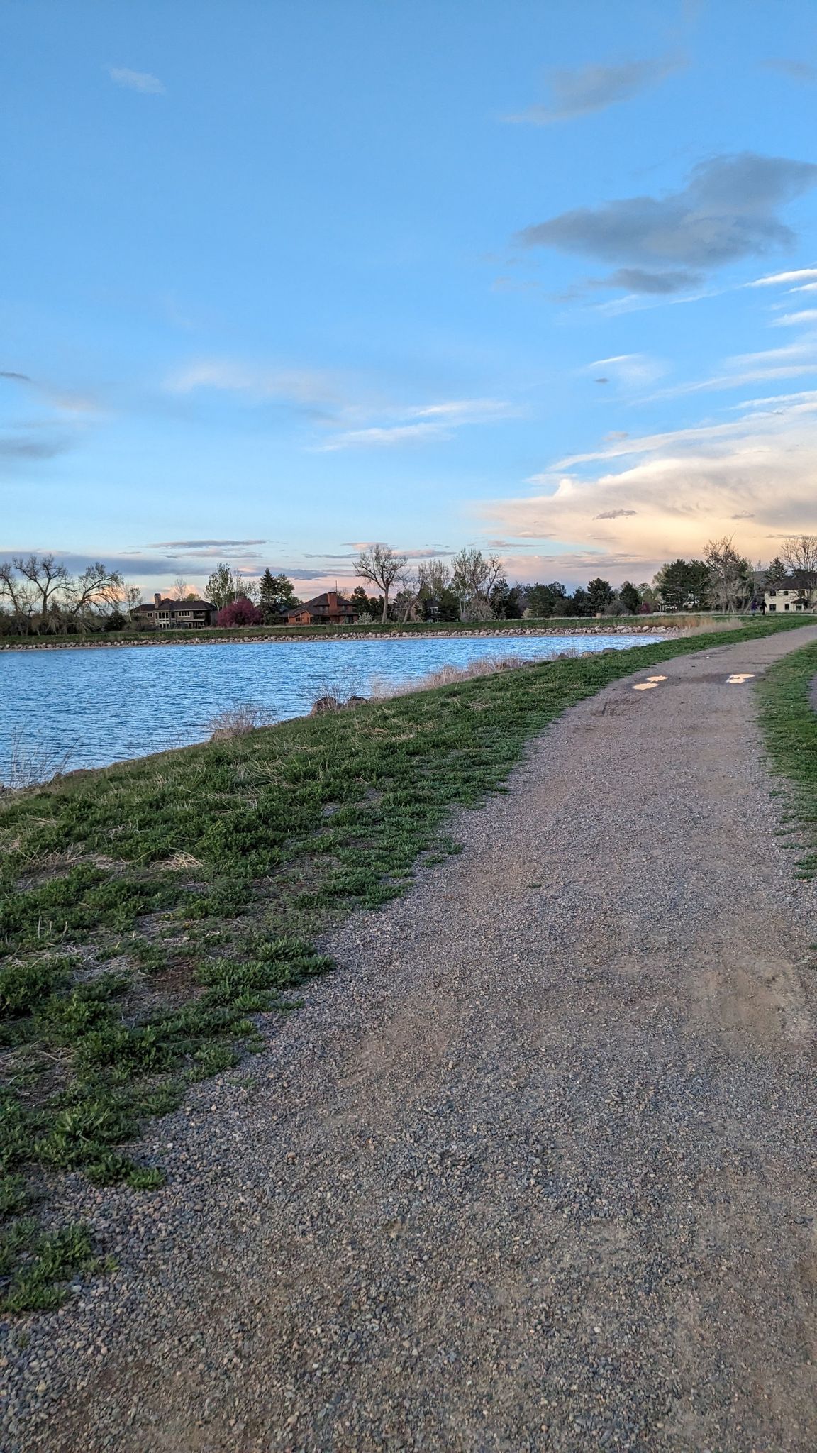 Gravel path beside a calm lake under a partly cloudy evening sky. - Davidson Mesa and Harper Lake Loop