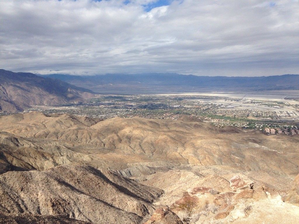 Panoramic view of arid mountains and a distant city under cloudy skies. - Murray Hill Loop – San Bernardino National Forest