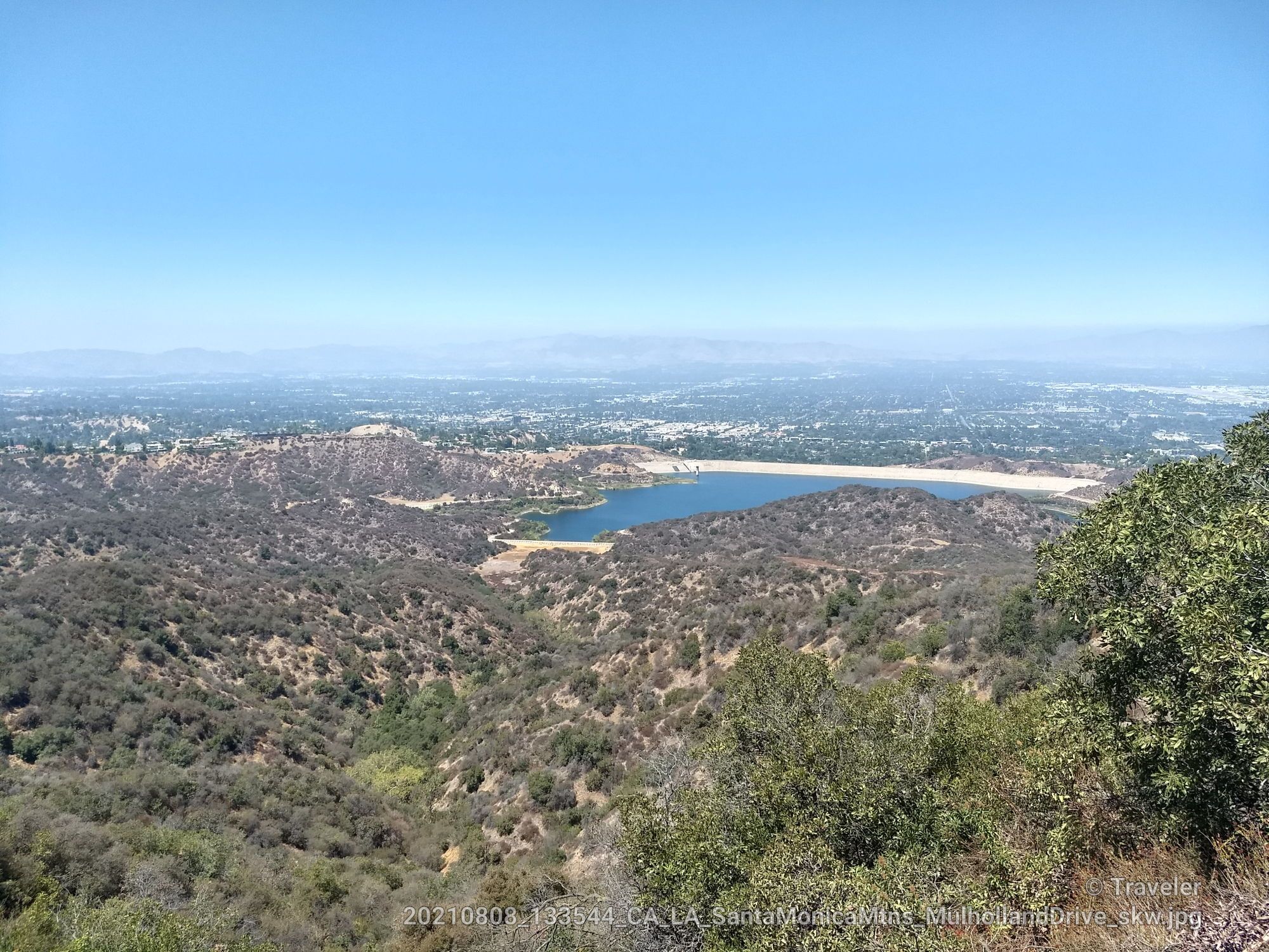 Panoramic view of a lake nestled in a valley of dry hills under clear sky. - San Vicente Mountain Viewpoint – West Mandeville Fire Road loop from Santa Monica Mountains