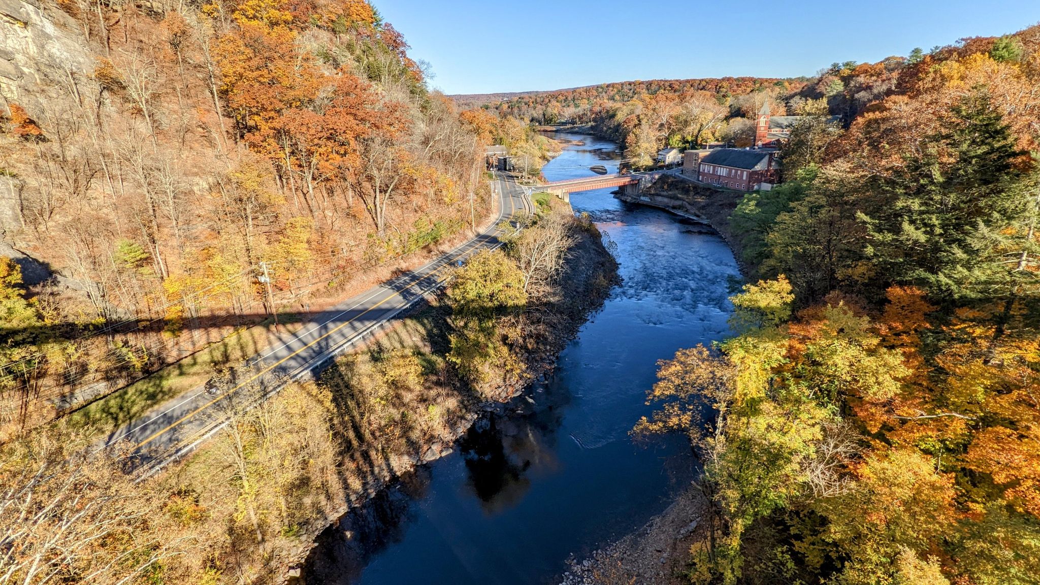 Sunny autumn view of a river flowing through a colorful, forested canyon. - Wallkill Valley Rail Trail