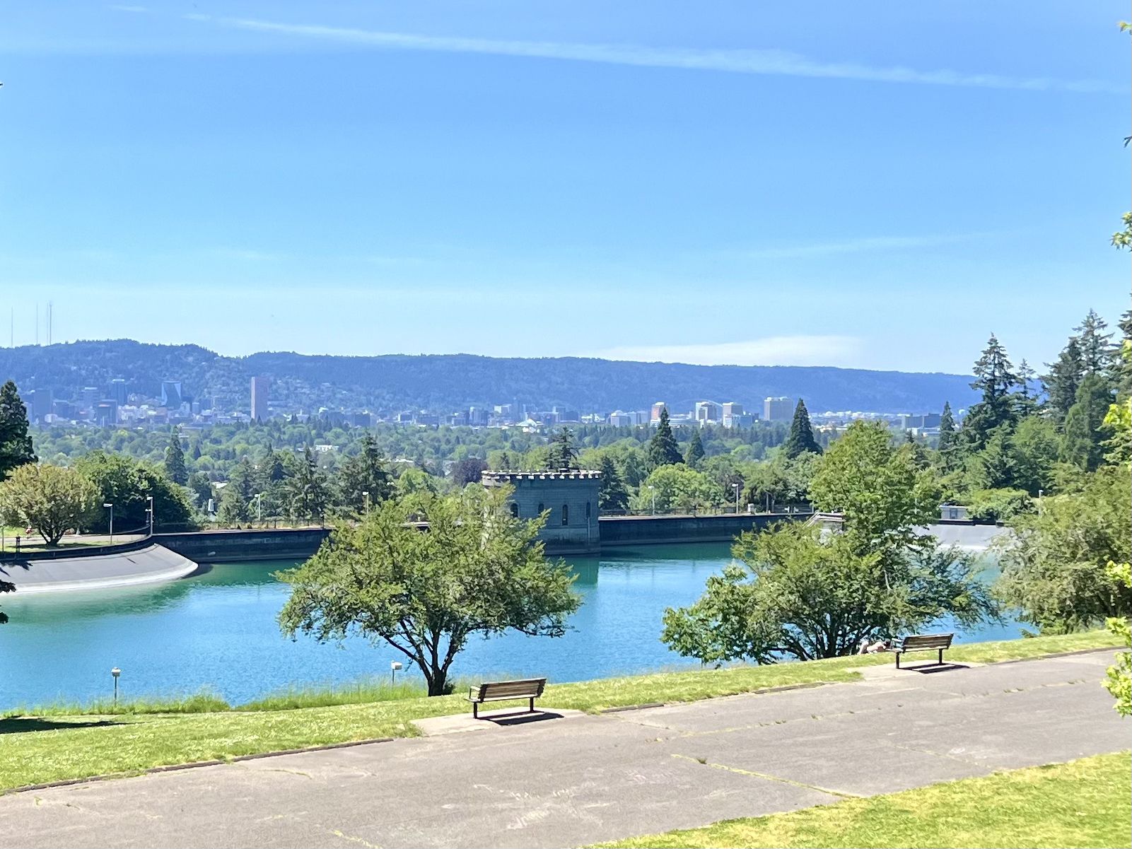 Bright sunny day over a reservoir with a distant city skyline. - Blumenauer Bridge – Mount Tabor loop from Mount Hood Avenue