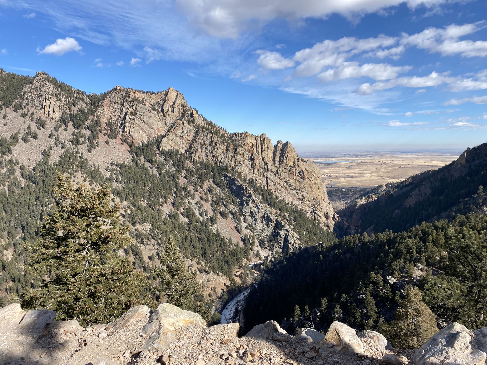 Expansive view of rugged mountains, a deep valley, and distant plains. - Rattlesnake Gulch Loop