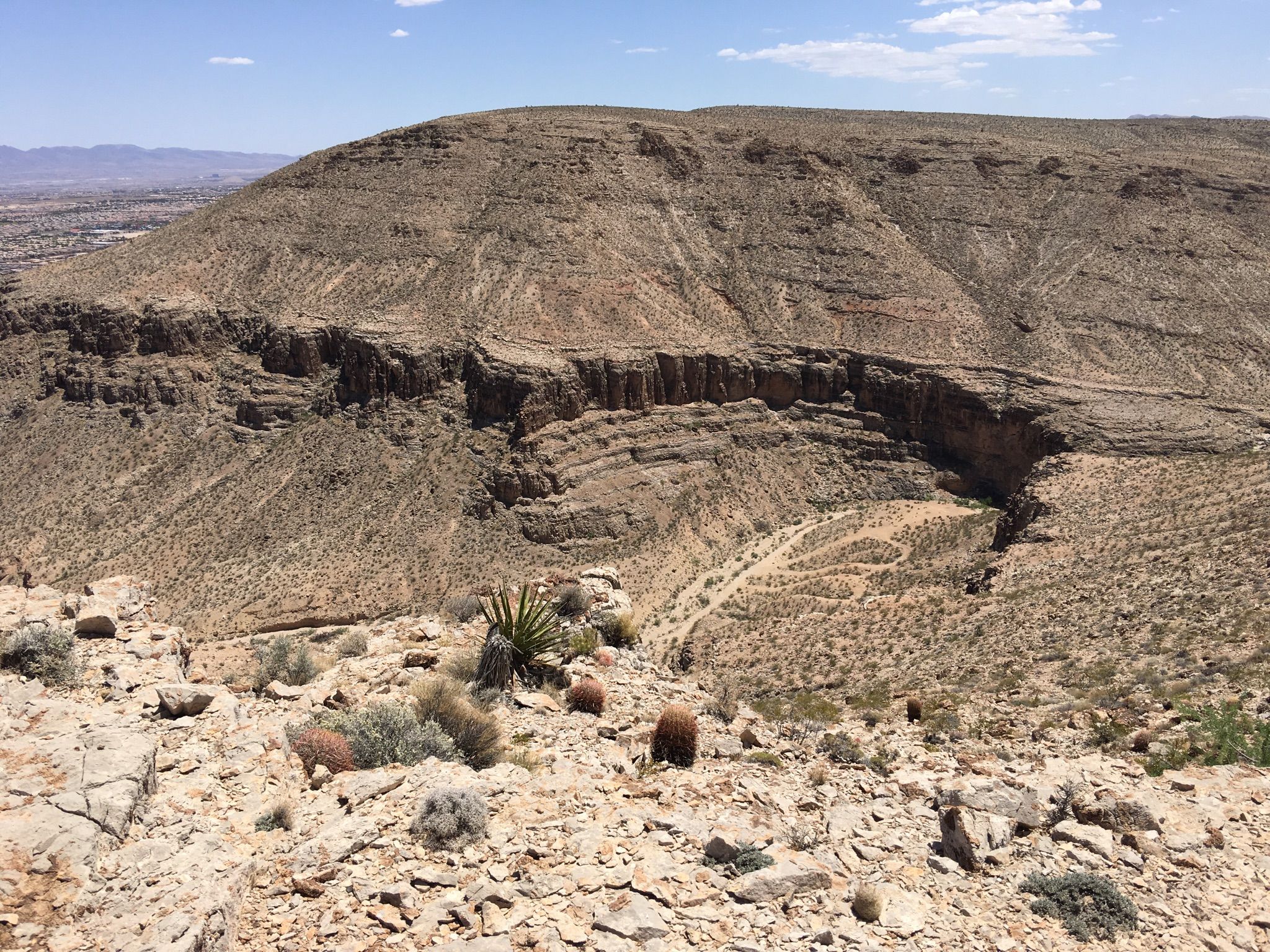 Sunny desert landscape with rugged hills, a deep canyon, and sparse vegetation. - Western Beltway Trail