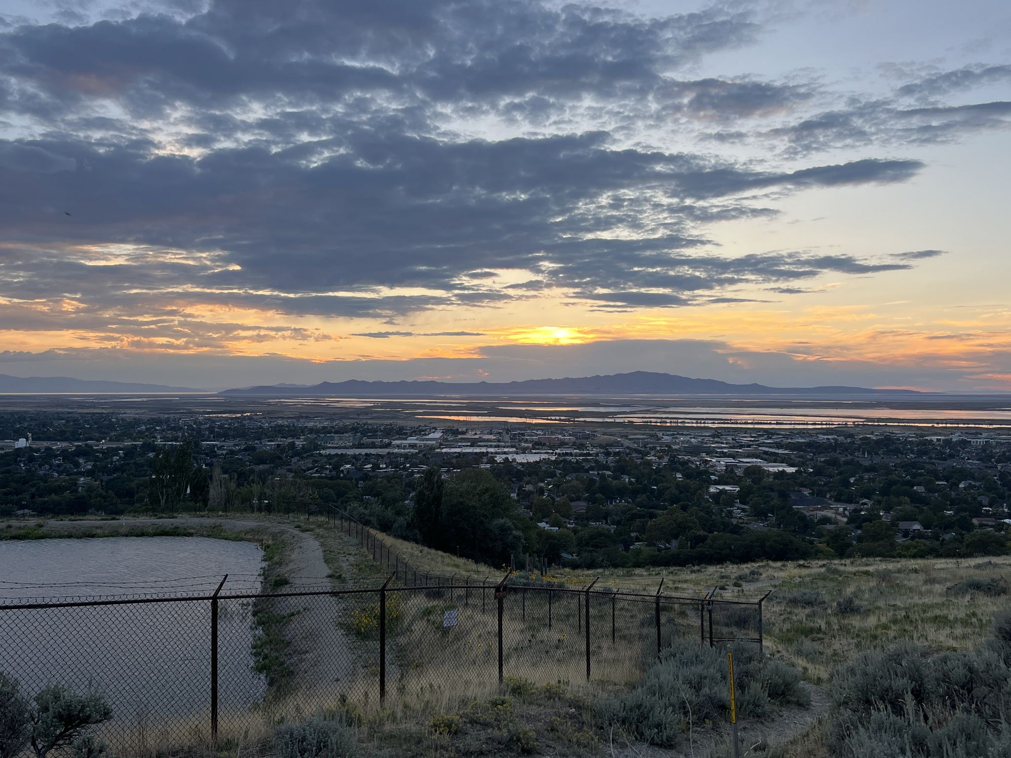 Dramatic sunset over a sprawling city and distant water, viewed from a hill. - Parrish Creek and Buckland Ridge Trail Loop