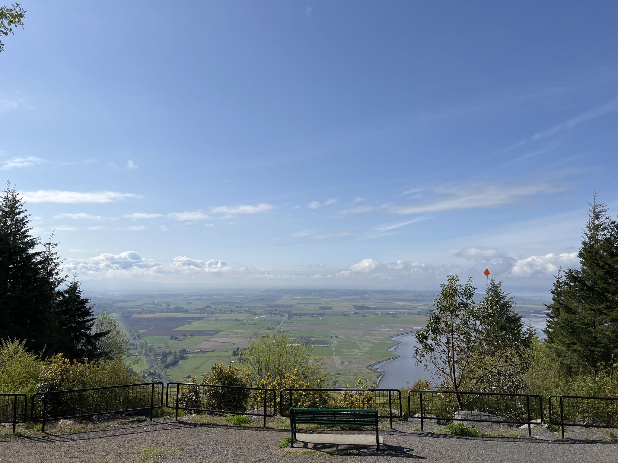 Scenic overlook with a green bench, railing, and vast valley view. - Samish Overlook – Oyster Dome Overlook loop from Blanchard EMS Checkpoint Yankee