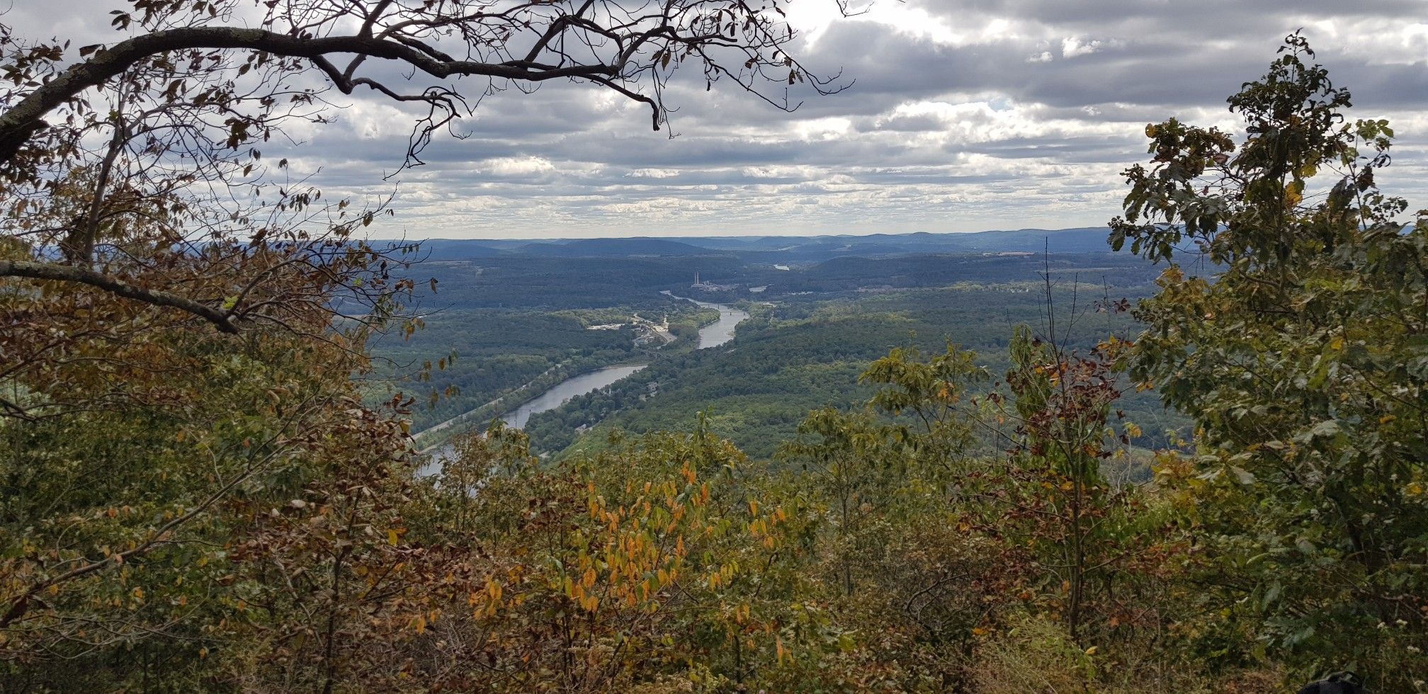 Overcast sky above a winding river through a vast forested valley. - Appalachian Trail: Mount Minsi