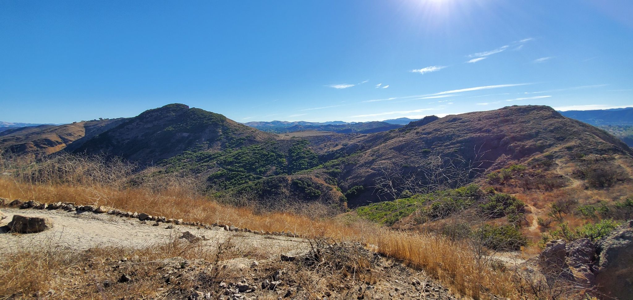 Panoramic view of rolling hills and valleys under a bright sunny blue sky. - Canyon Overlook Trail to Wildwood Canyon Trail Loop