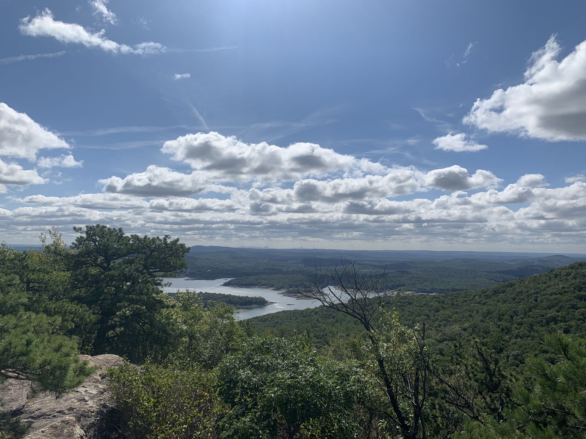 Bright sunny day over a winding lake surrounded by green forested mountains. - Wyanokie High Point and Chikahoki Falls Loop