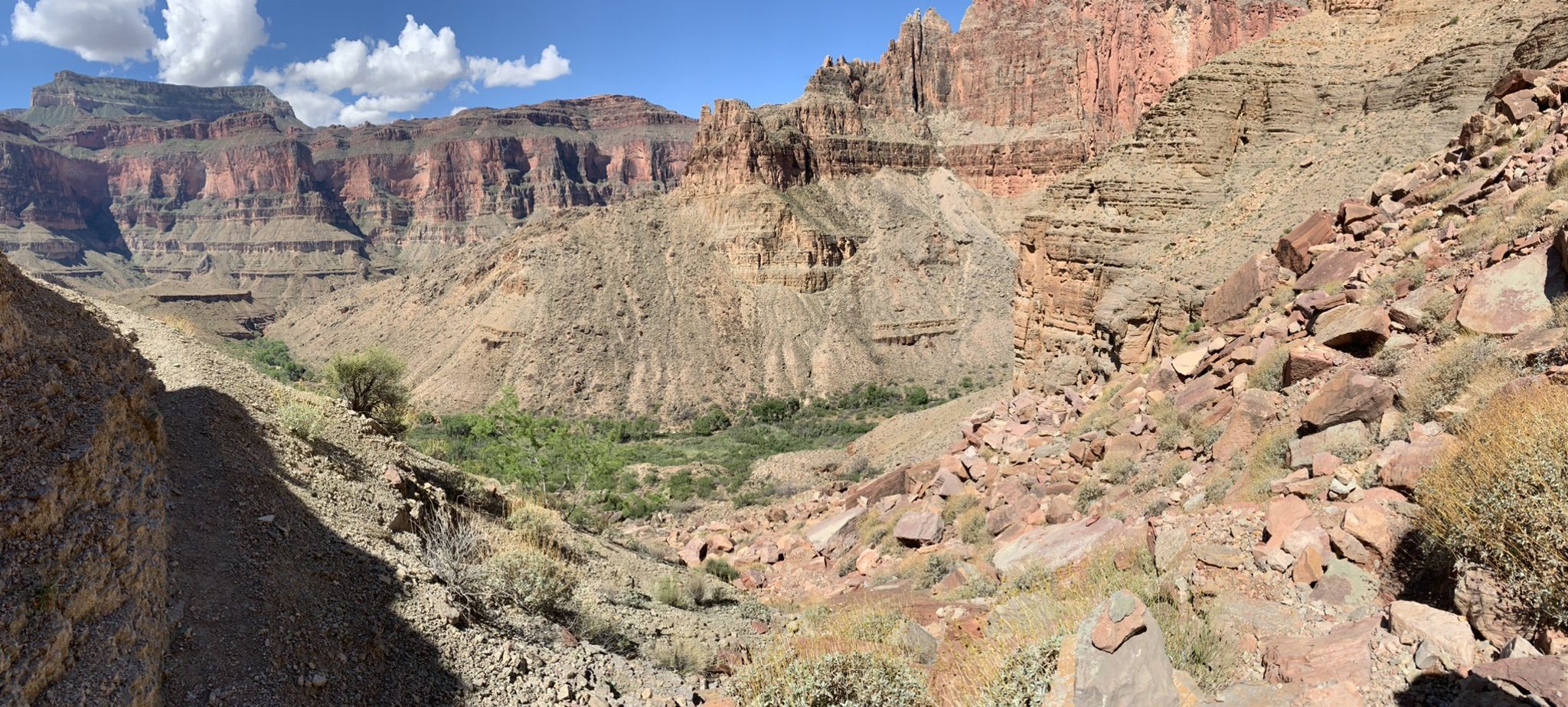 Deep canyon with green vegetation in the valley, rocky slopes, and blue sky. - Bill Hall, Deer Creek,Tapeats Creek, and Thunder River Loop