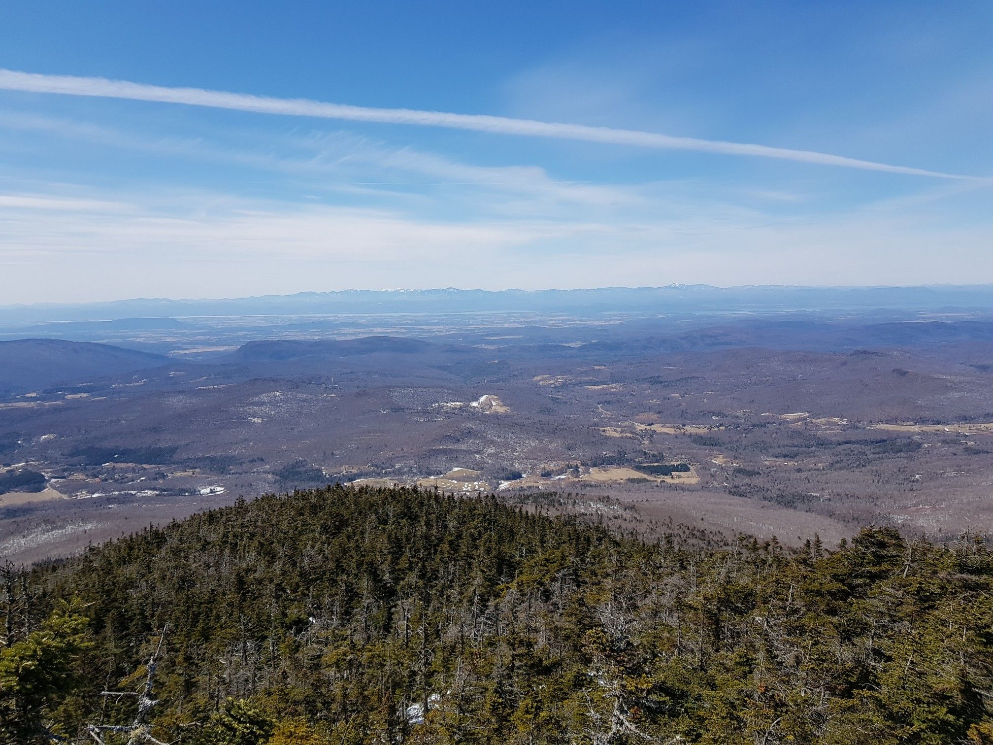 Vast mountain landscape with distant valleys under a bright, clear sky. - Long Trail: Stark Mountain and Mount Ellen