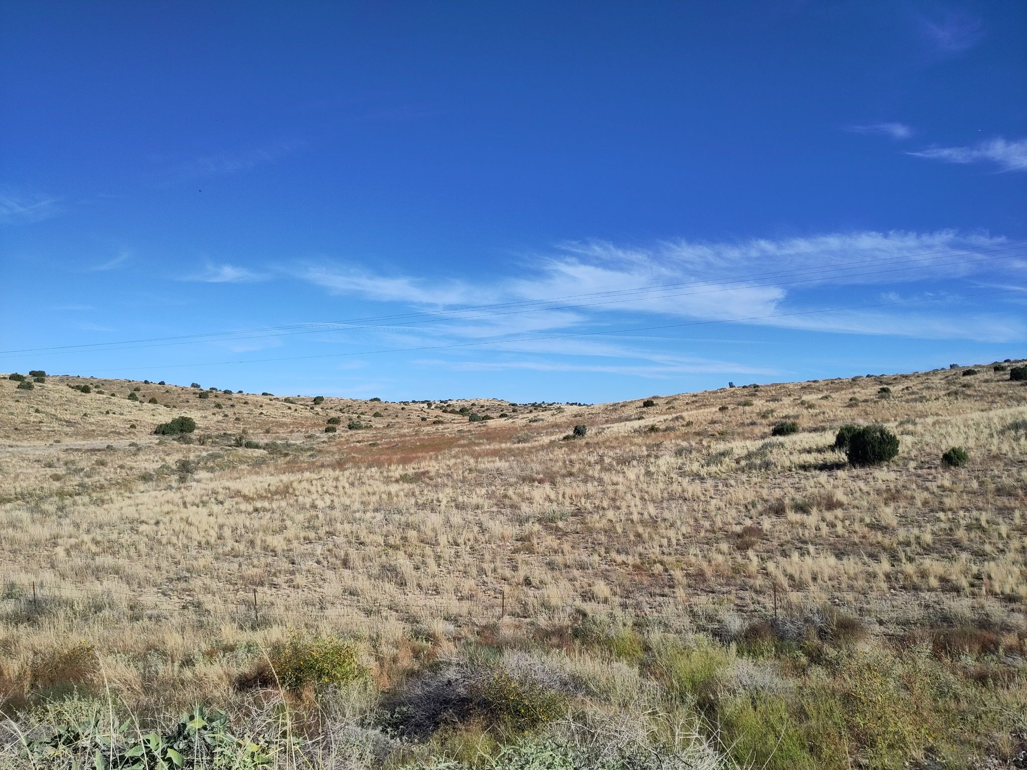 Expansive dry grassy hills under a clear bright blue sky. - Hackberry General Store to Grand Canyon Caverns via Route 66