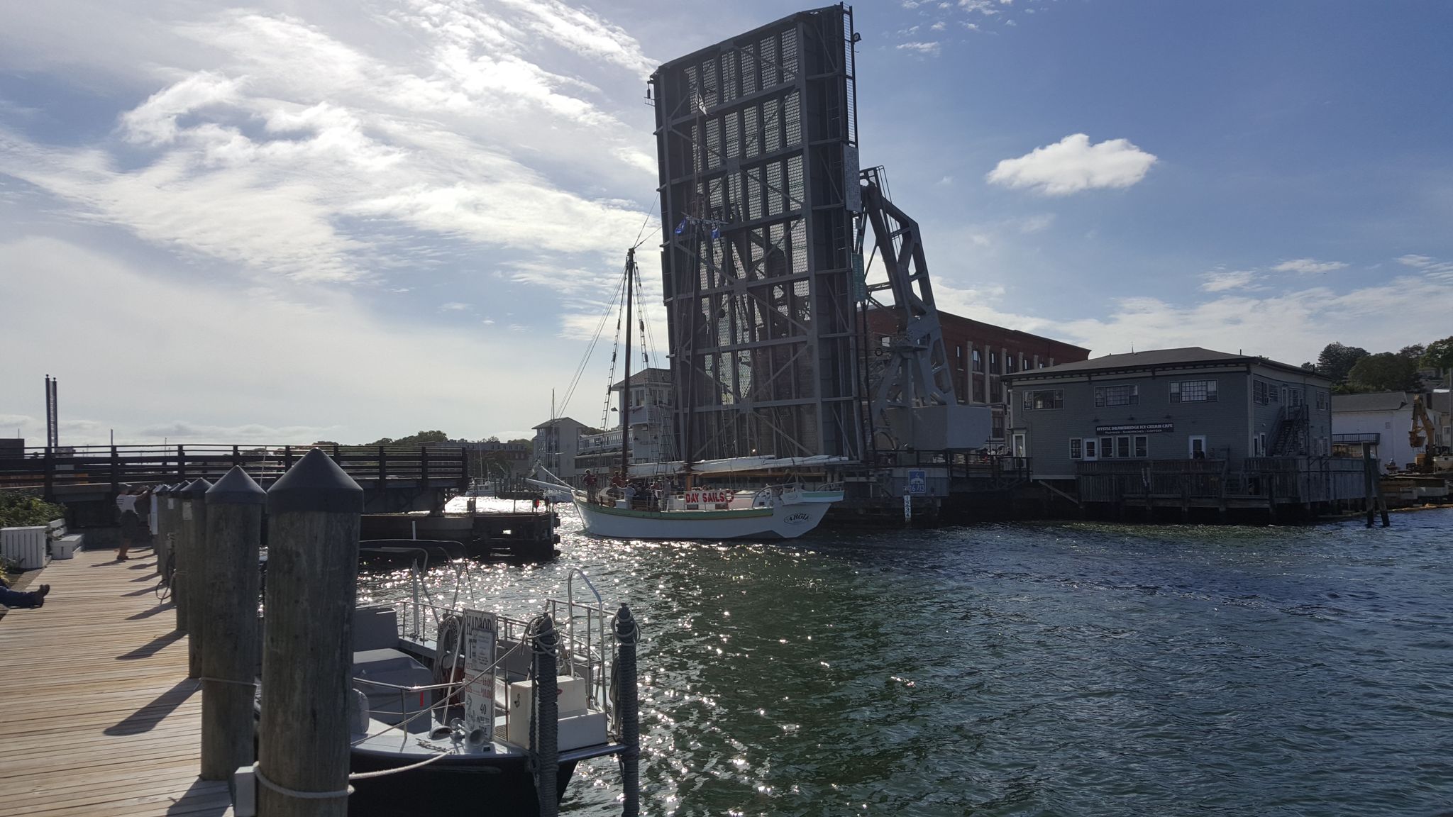 A raised drawbridge over water with boats and docks on a sunny day. - Union Baptist Church – Hoxie Scenic Overlook loop from Groton Long Point