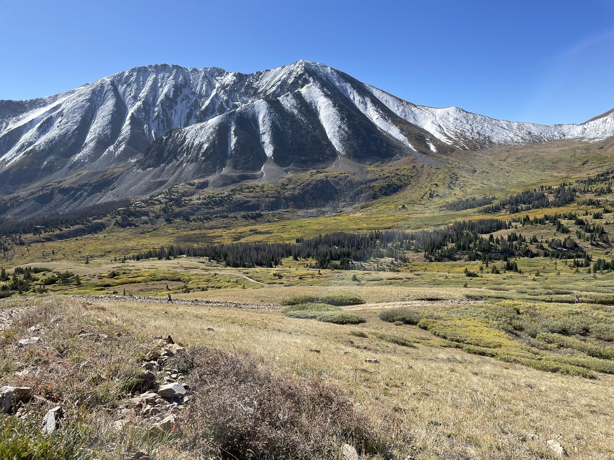 Sunny mountain landscape with snow-capped peaks, golden valleys, and distant hikers. - Browns Creek and Little Browns Creek Loop