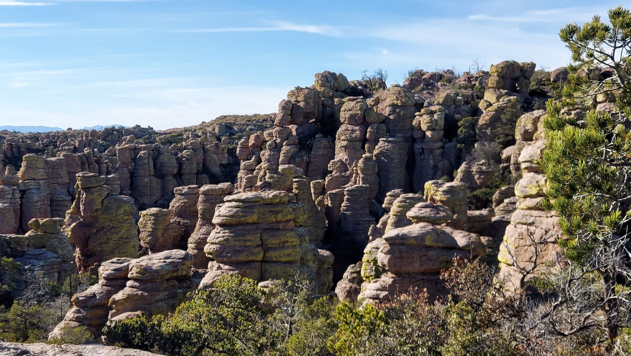 A dense cluster of stacked rock formations under a bright, partly cloudy sky. - Balanced Rock in Echo Canyon – Echo Park loop from Chiricahua National Monument