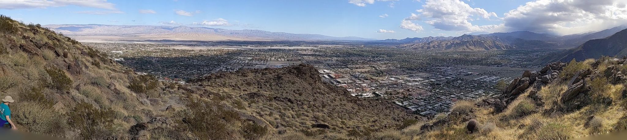Panoramic view of a desert valley town from a rocky mountain slope. - Skyline Trail – Downtown Palm Canyon Drive loop from Palm Springs