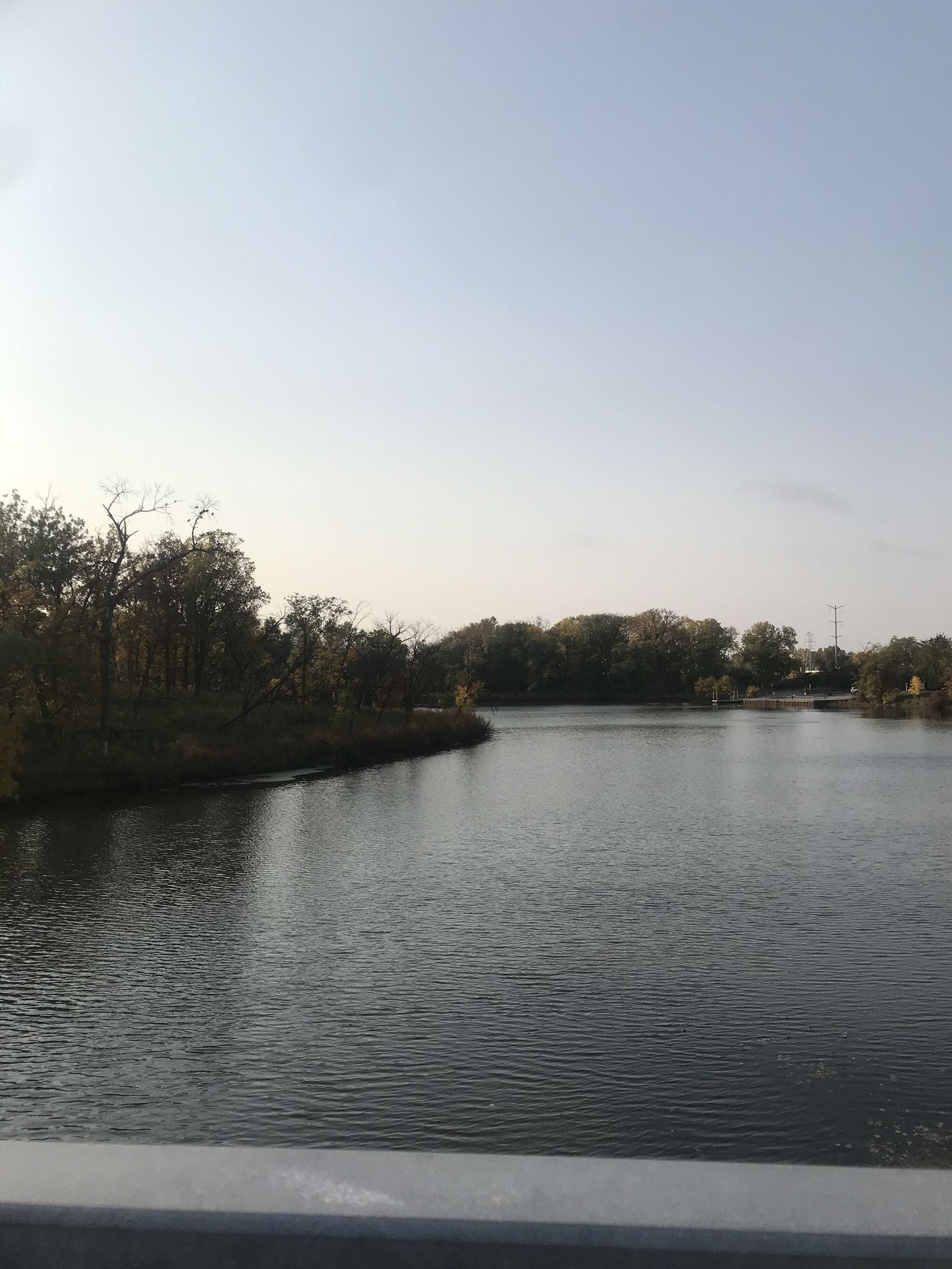 Wide river with wooded banks under a bright, clear sky. - North Branch Trail: Skokie Lagoons Loop