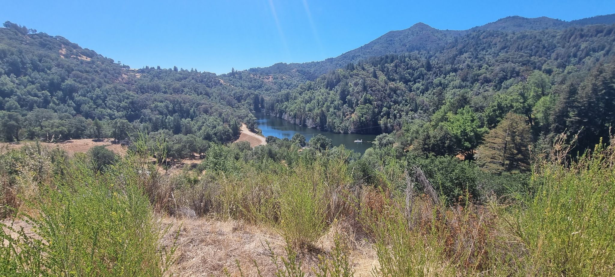 Sunny panoramic view of a valley with a winding river and green hills. - Phoenix Lake – Natalie Coffin Park loop from San Anselmo