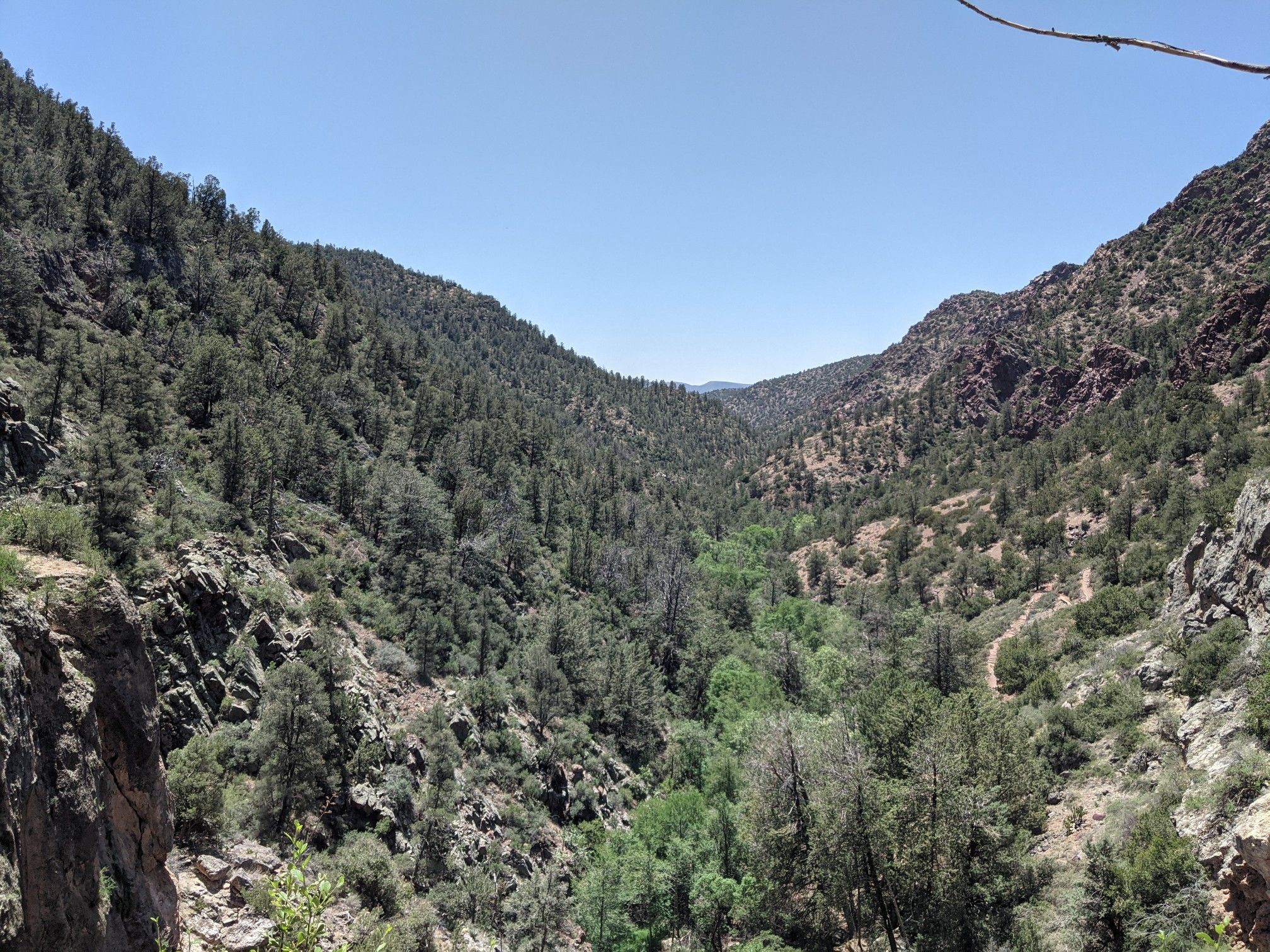 Deep, forested canyon under a bright, clear sky. - Pine Creek, Anna Mae, Gowan, and Waterfall Loop
