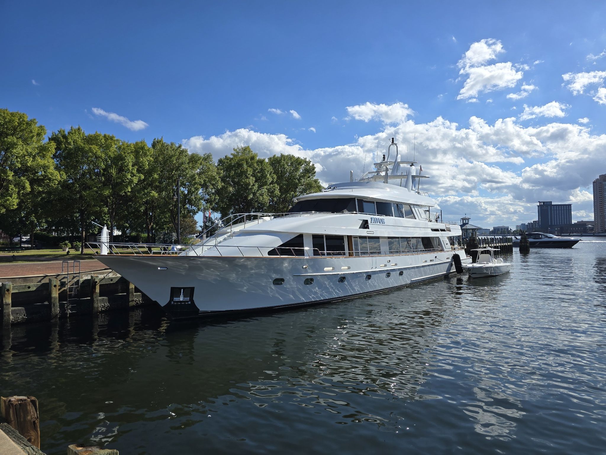 Large white yacht docked on calm water under a bright, cloudy sky. - Elizabeth River Trail and Ocean View Loop