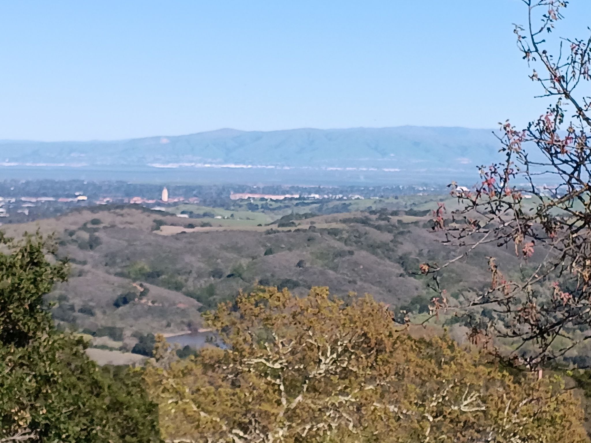 Expansive view of a valley with distant city and rolling hills. - Old La Honda Road