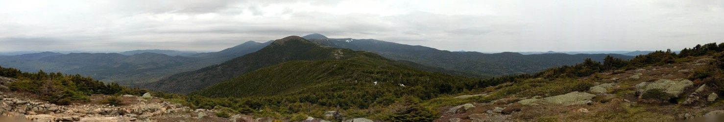 Wide panoramic view of rolling green mountains under a cloudy, grey sky. - Crawford Path
