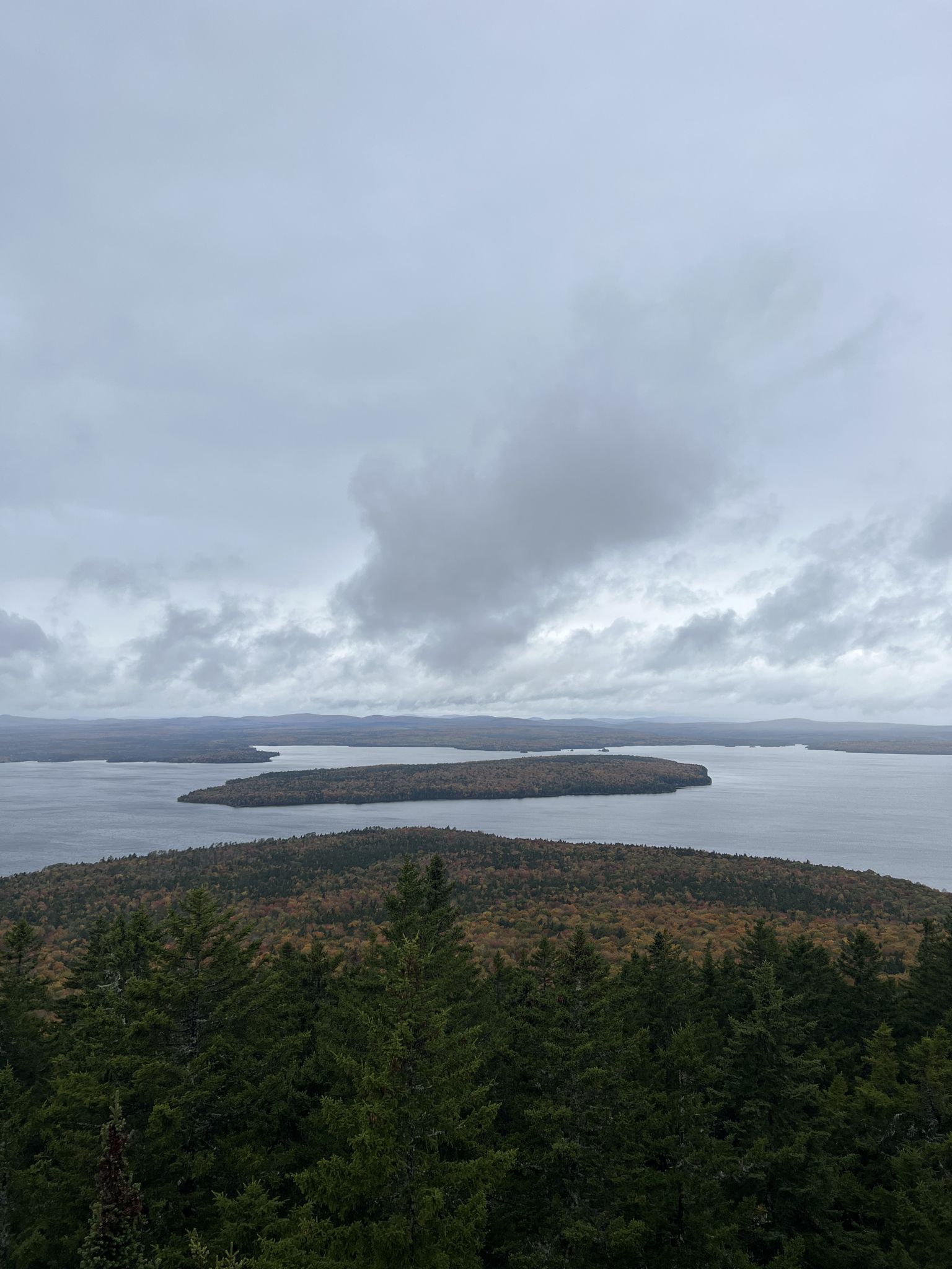Overcast aerial view of forested islands in a large body of water. - Mount Kineo loop from Rockwood