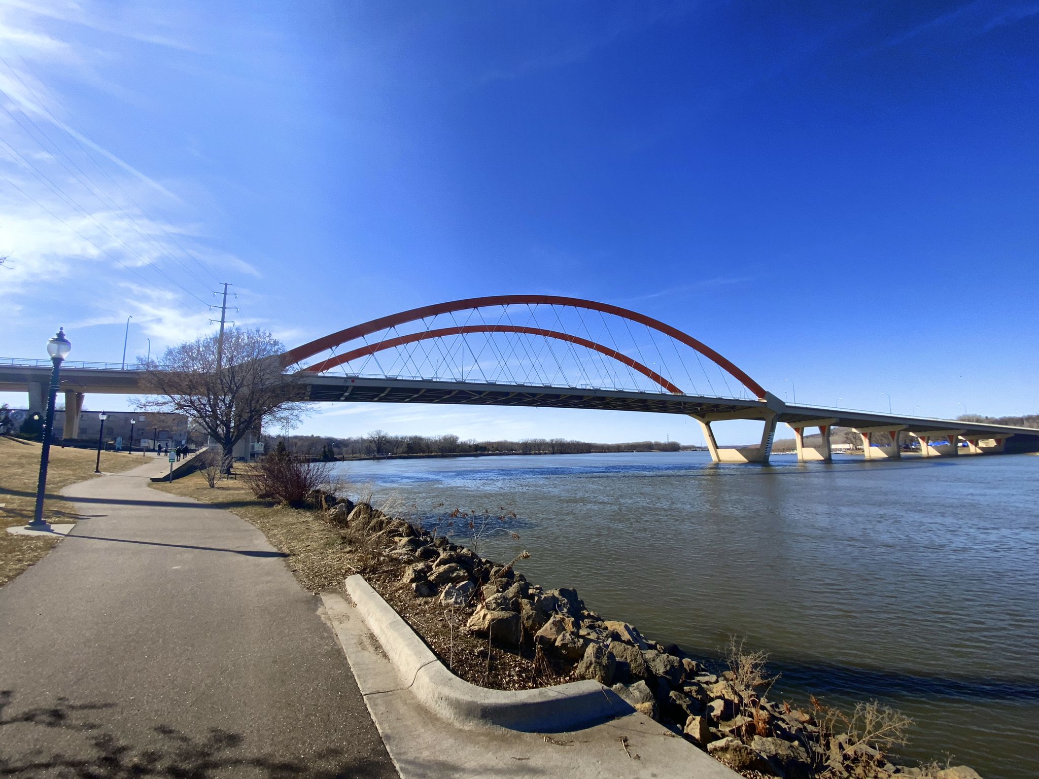 A large arched bridge spans a wide river under a clear blue sky. - Vermillion River: Old Mill Park to Vermillion Slough