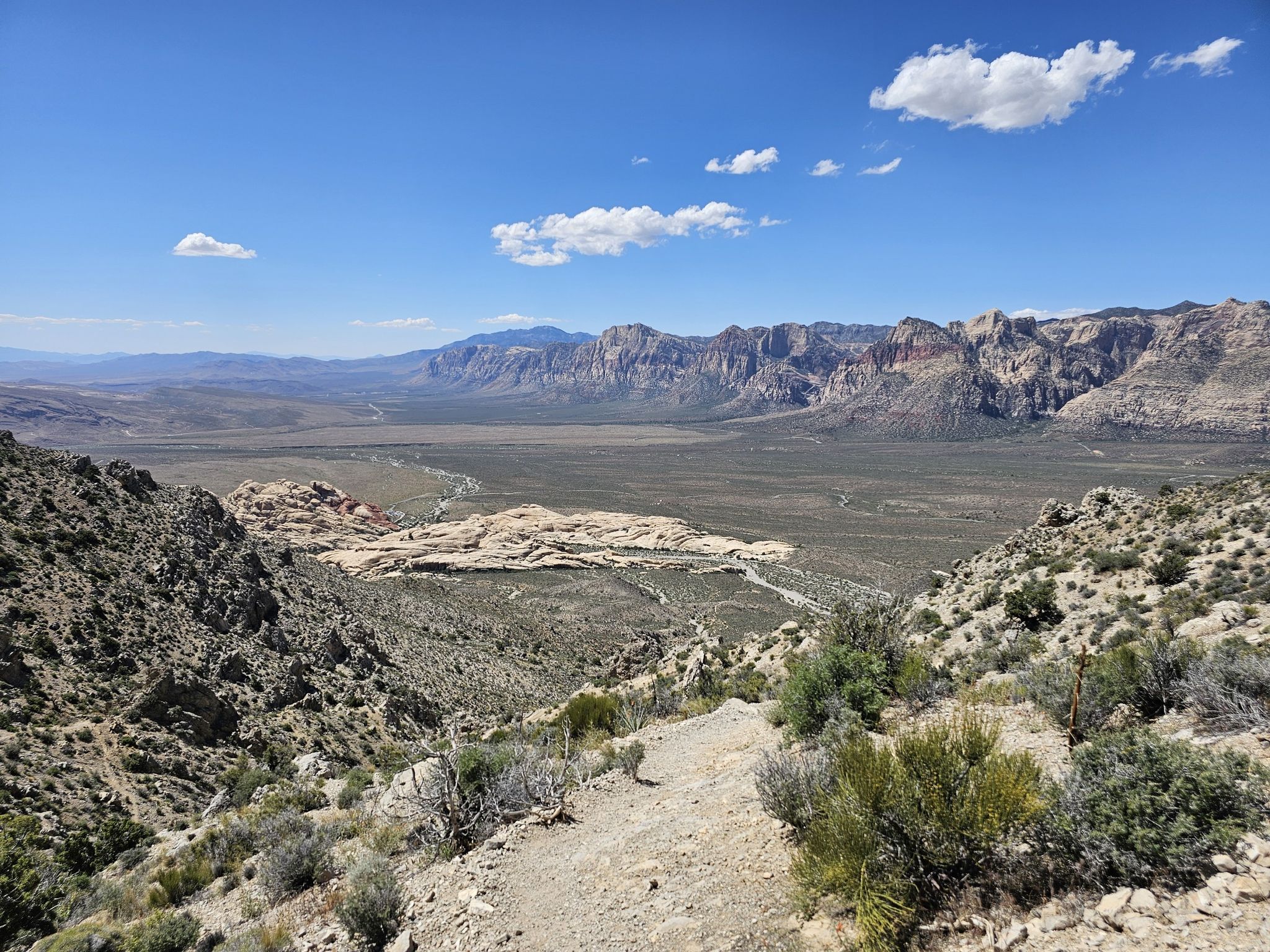 Wide desert valley with distant mountains under a clear blue sky. - Sandstone Quarry – Turtlehead Peak loop from Red Rock Canyon Visitor Center