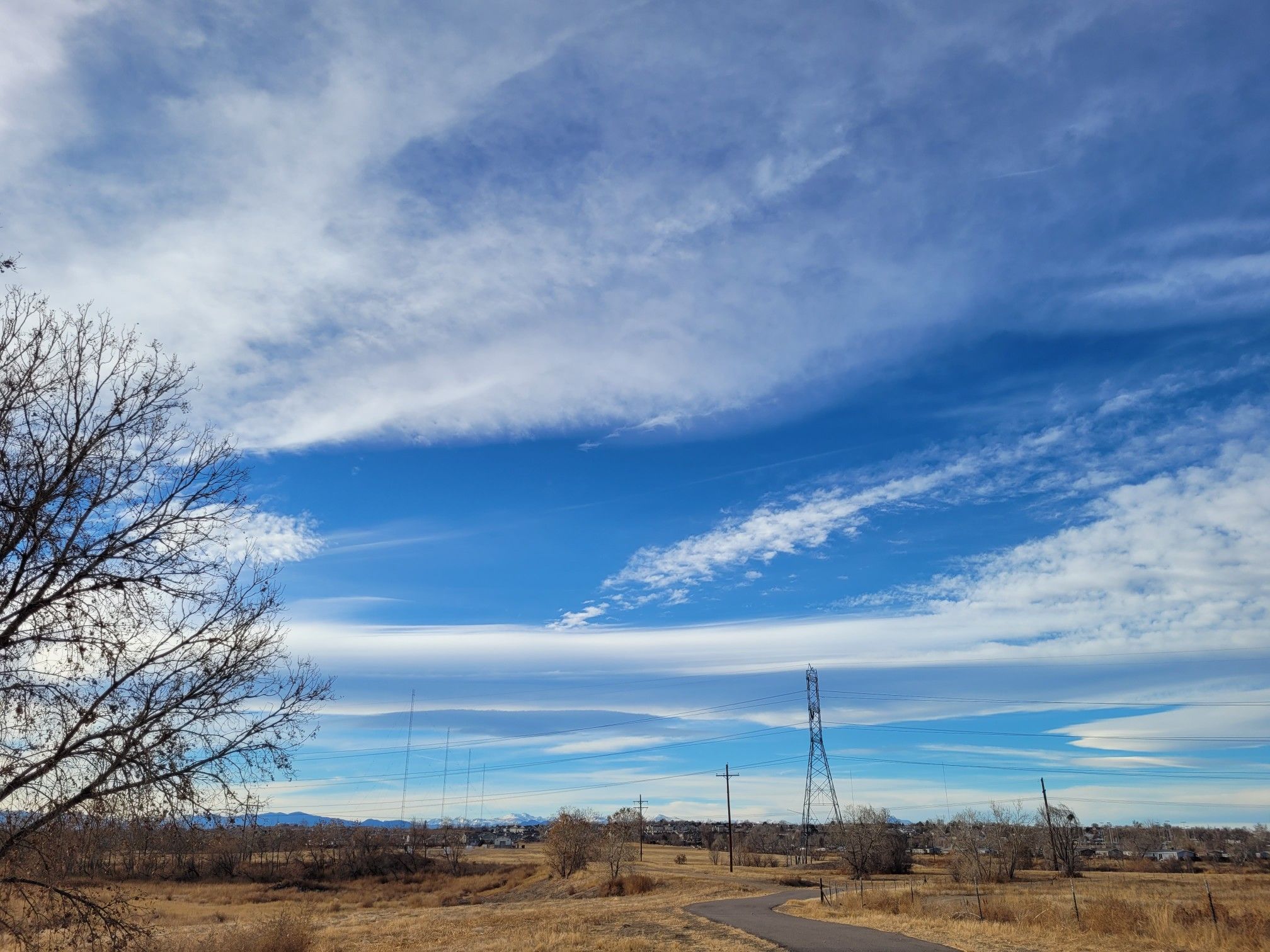 Expansive blue sky with wispy clouds over a dry, open landscape. - Valente Lake – South Platte River Trail loop from Brighton