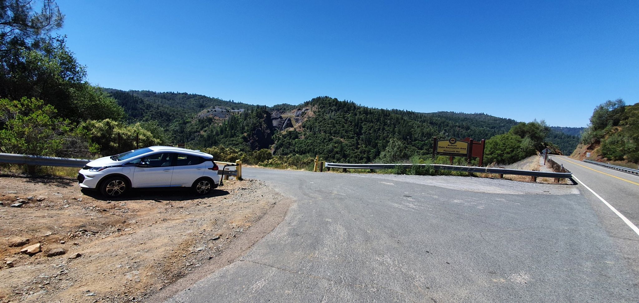 A white car parked on a dirt shoulder next to a road. - Fuel Break Trail – Old Auburn Foresthill Road loop from North Fork Dam