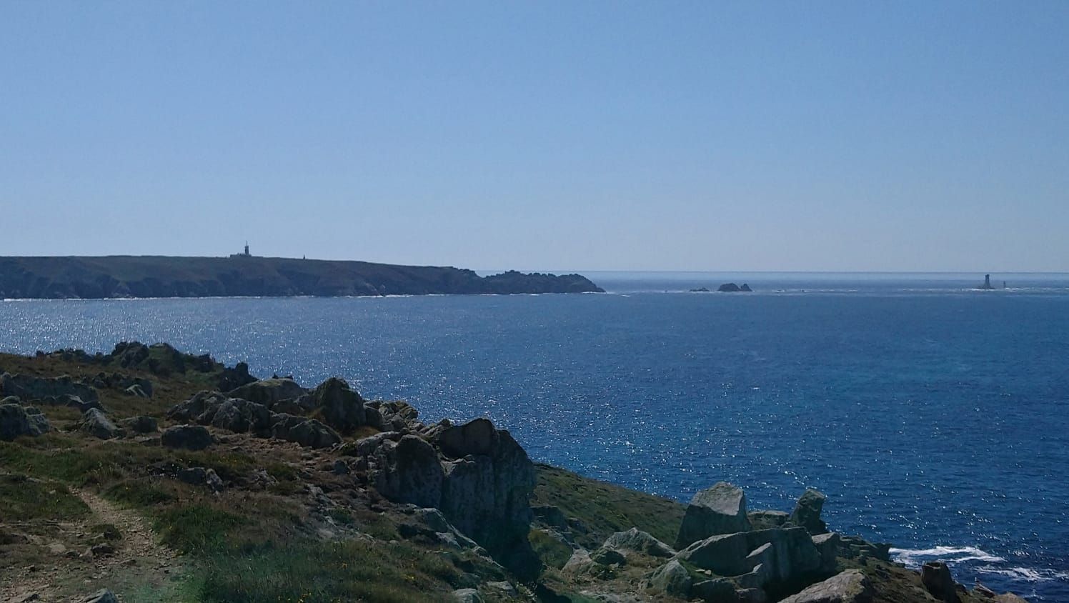 Rugged coastline with rocks overlooking a vast blue ocean under a clear sky. - San Diego Creek Trail – Walnut Trail loop from University of California, Irvine