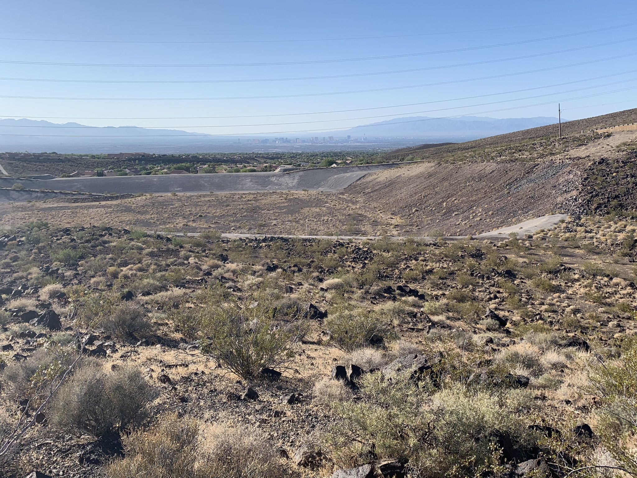Desert landscape with dry brush, rocky terrain, and distant mountains under clear sky. - 403 Trail and Park Peak Loop