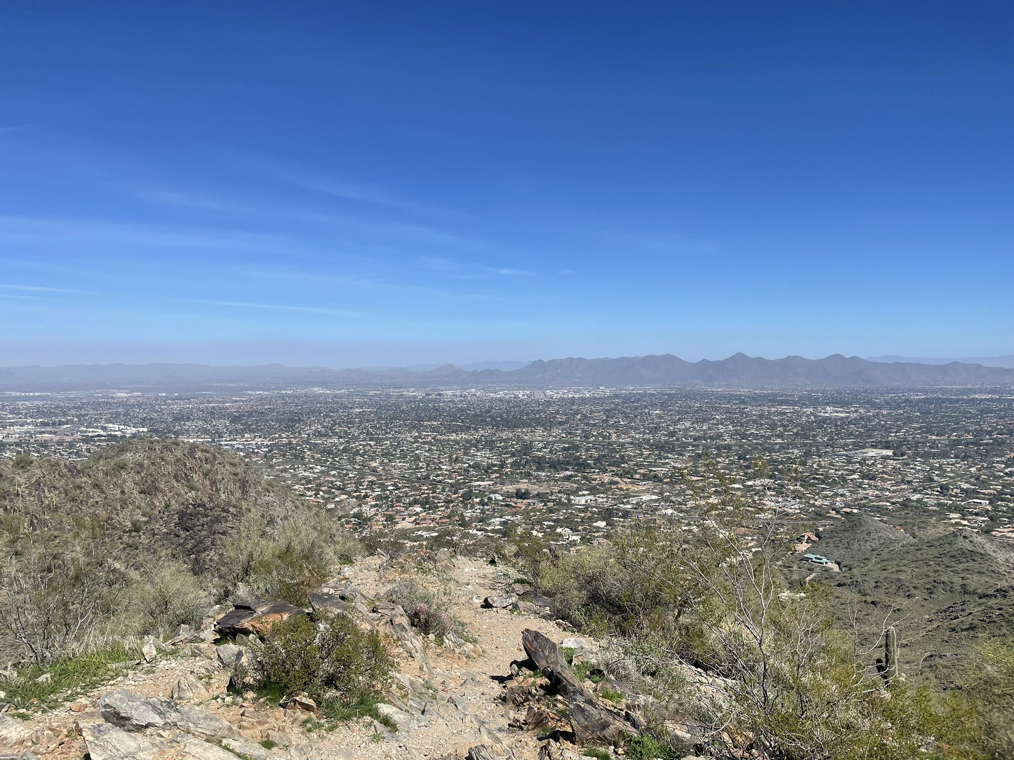 Panoramic view of a sprawling city from a desert mountain on a clear day. - Dixie Peak Trail