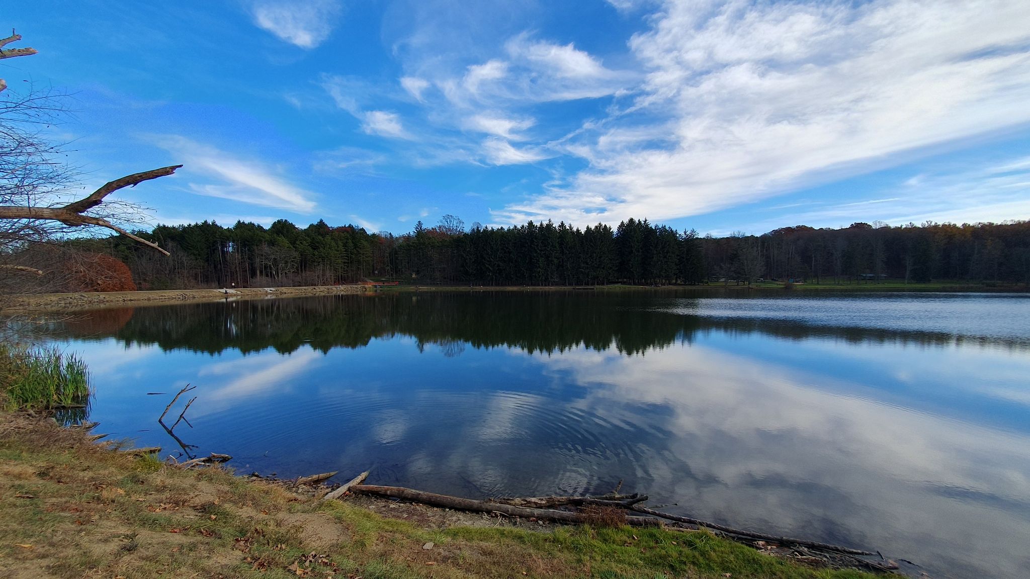 Wide lake reflecting a dramatic blue sky with wispy white clouds. - Accessible path loop from Luxor