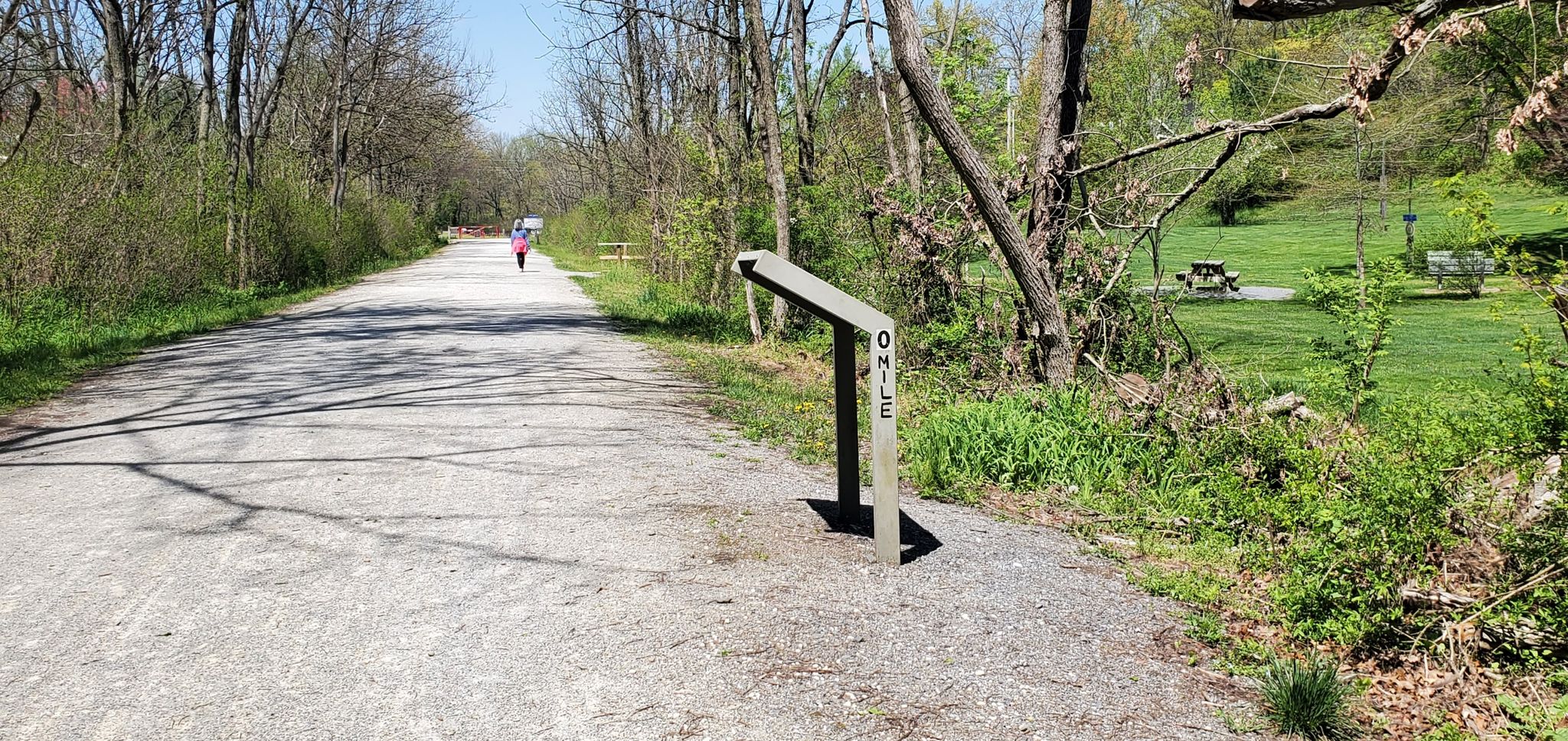Gravel path with mile marker, person walking, sunny day. - New Freedom Rail Trail – New Freedom loop from Beetree Run