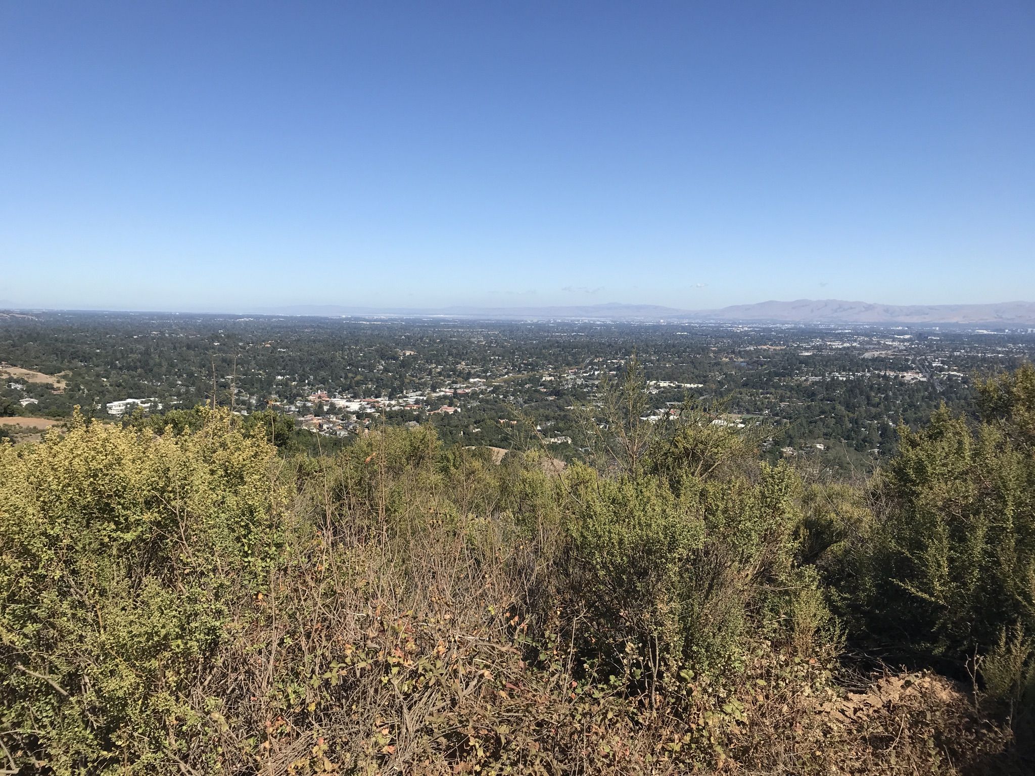 Sunny panoramic view of a distant town and mountains. - Saint Josephs Hill summit loop from Los Gatos